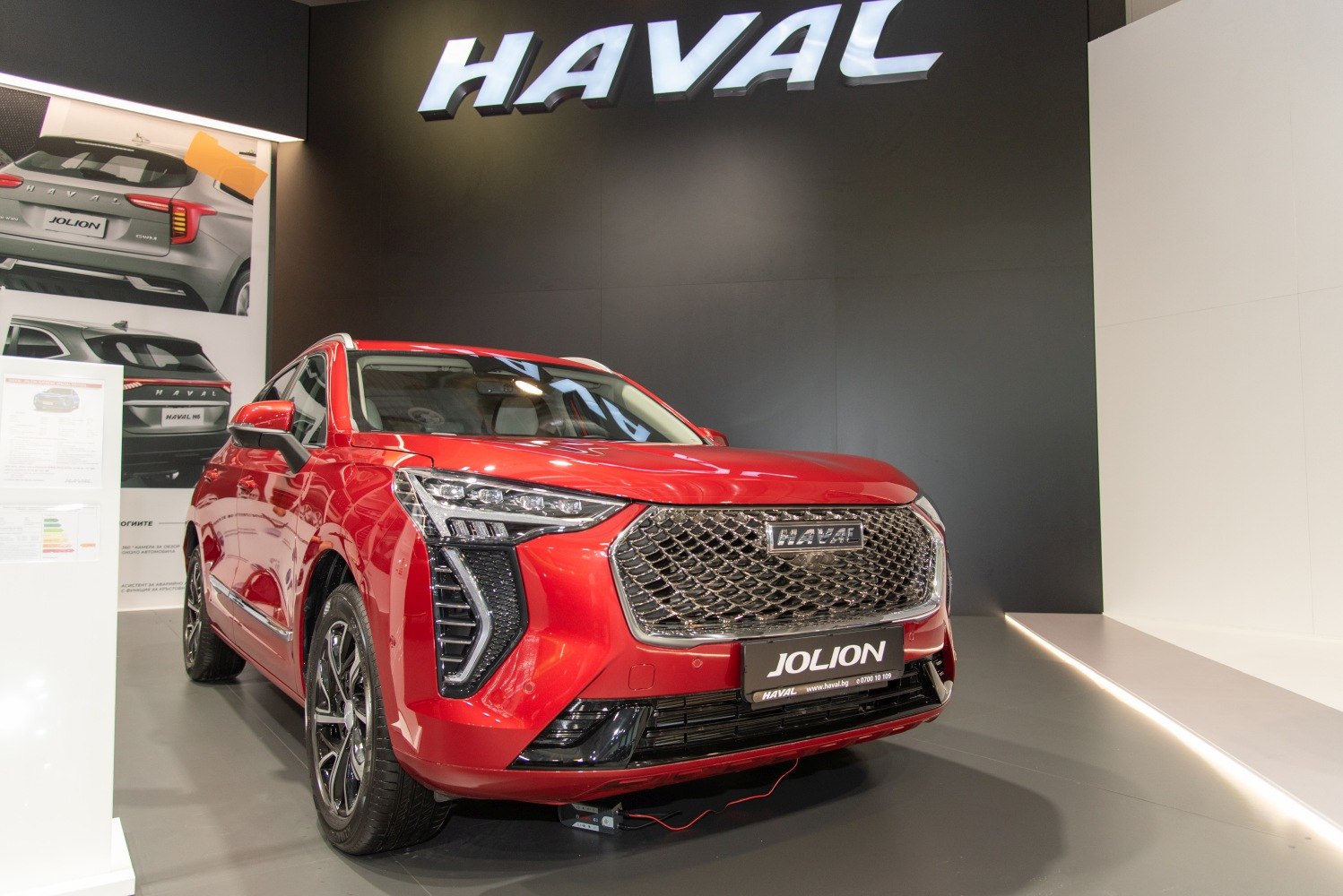 Red SUV front with mesh grille and angular LED headlights