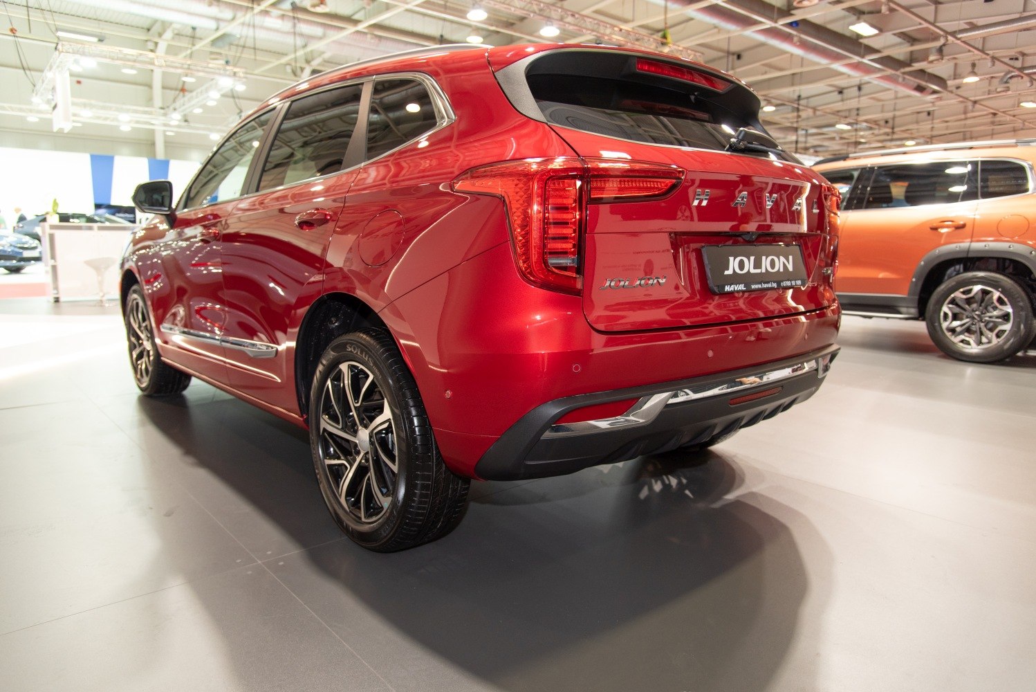 Red SUV rear view with LED tail lights and alloy wheels