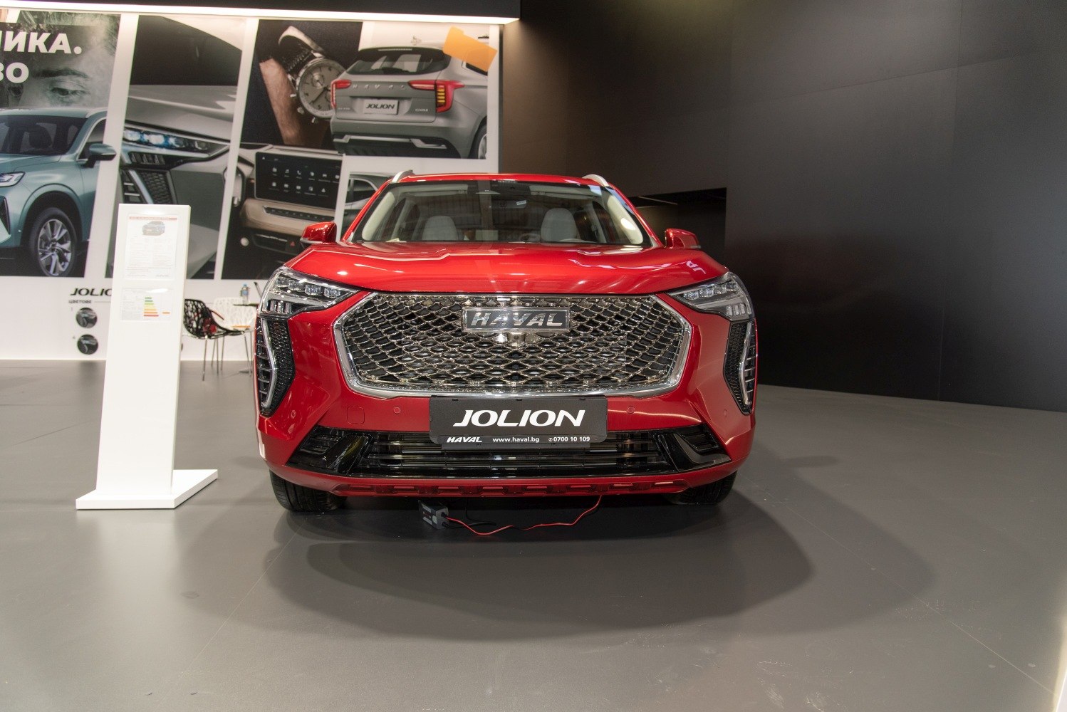 Front of vehicle with large mesh grille and angular LED headlights