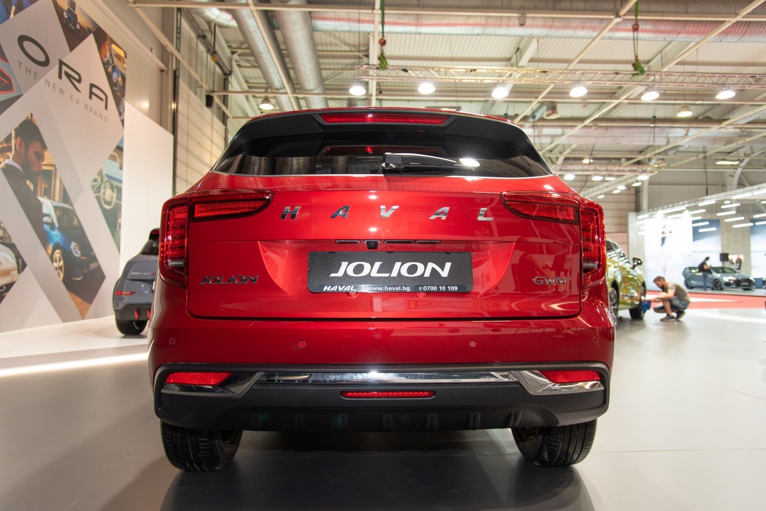 Rear view of a red SUV with detailed taillight and branding