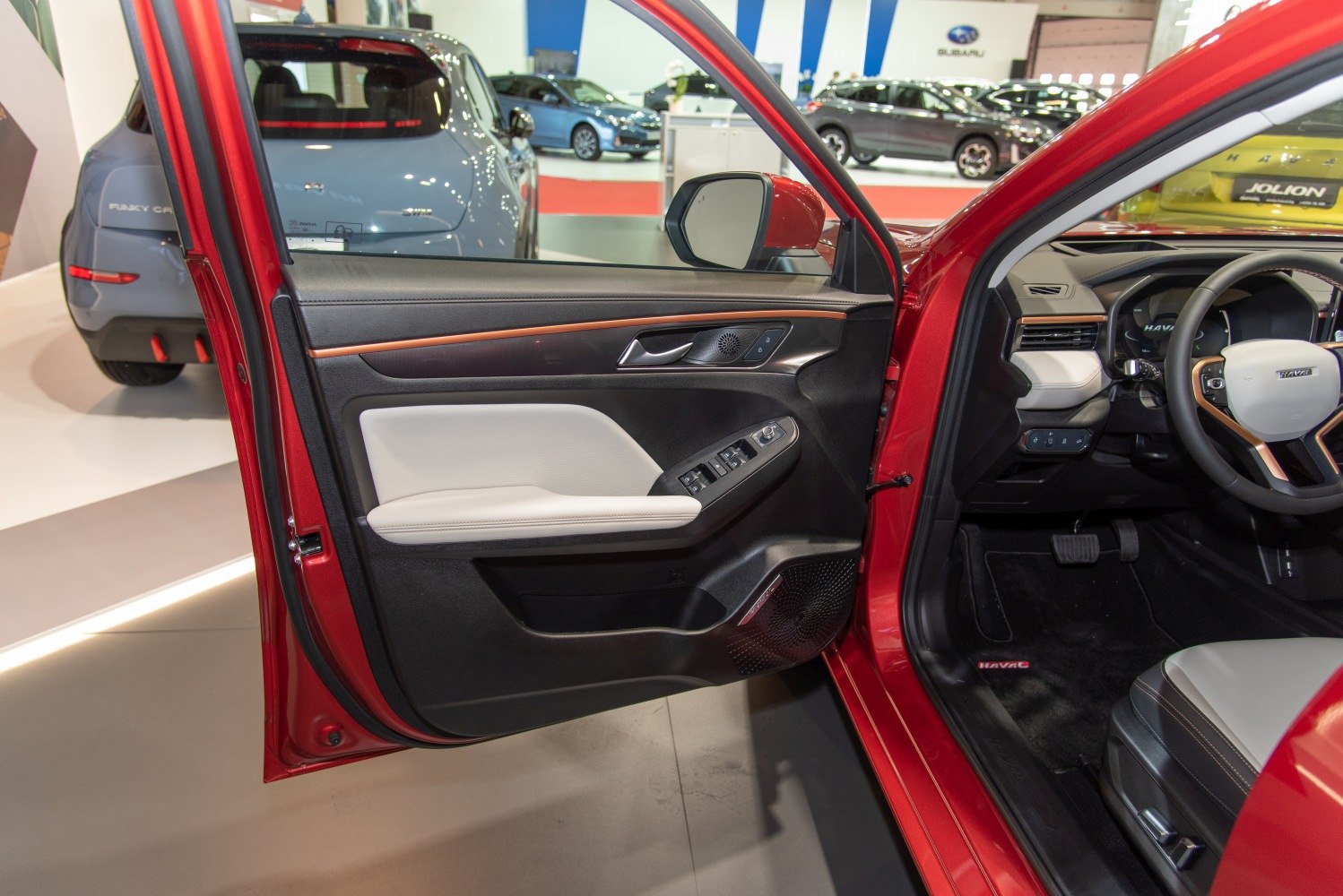 Interior door panel with controls, driver cockpit with steering wheel and pedals