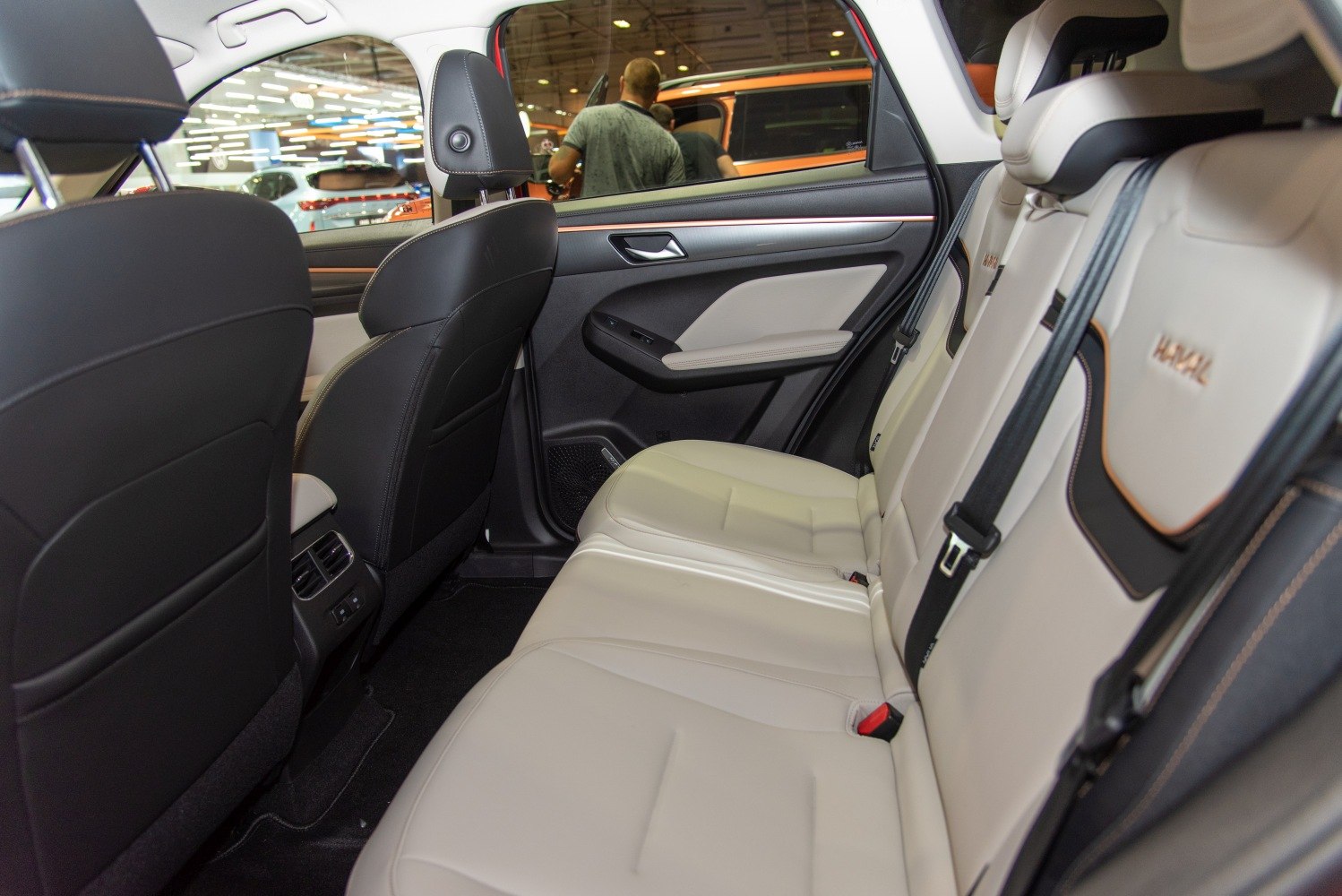 Spacious beige leather rear seats with door panel details