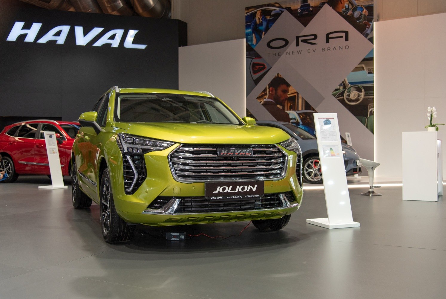 Lime green SUV front with LED headlights and chrome grille.