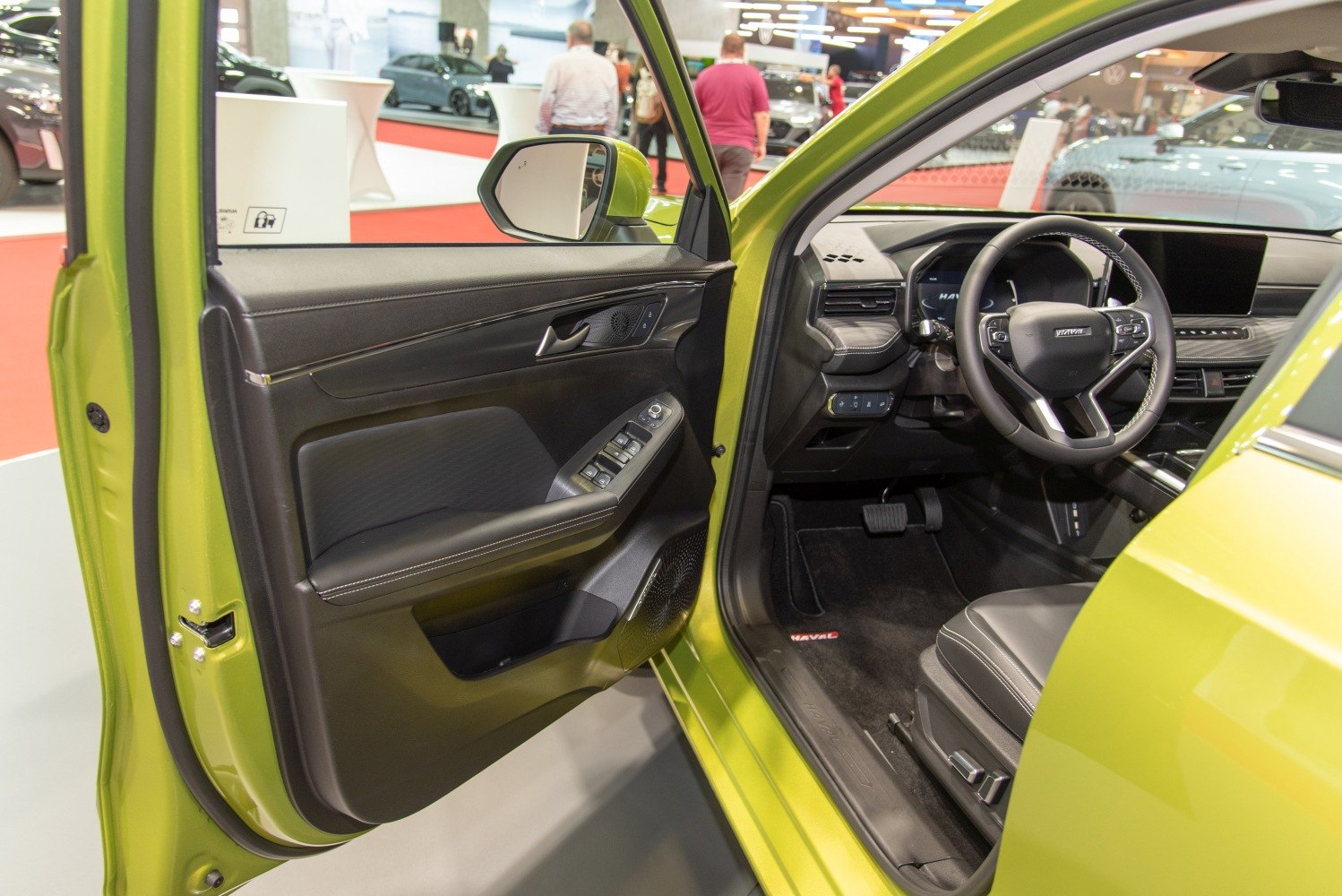 Driver door panel and steering wheel with dashboard of a modern car interior