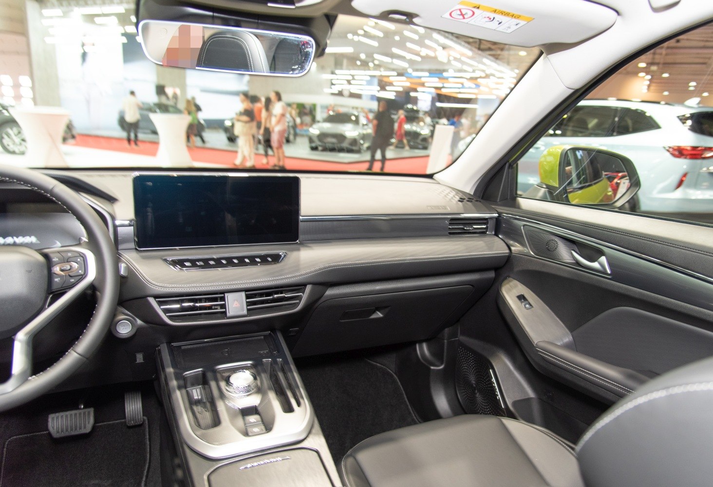 Modern car interior with touchscreen dashboard and rotary gear selector
