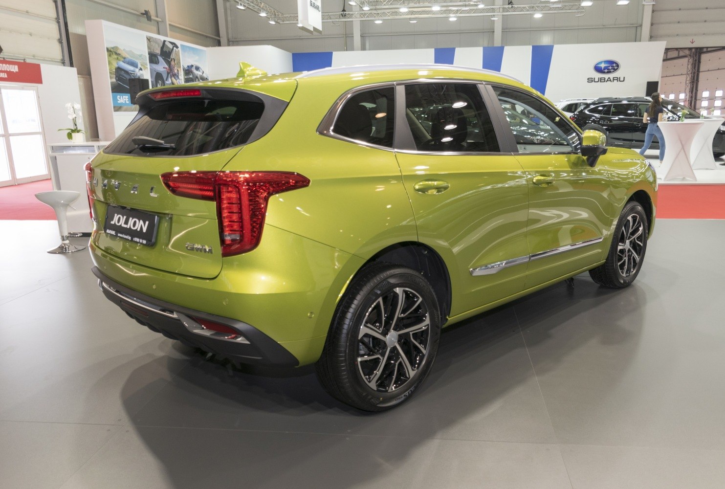 Rear and side view of a green SUV with sleek taillights and alloy wheels