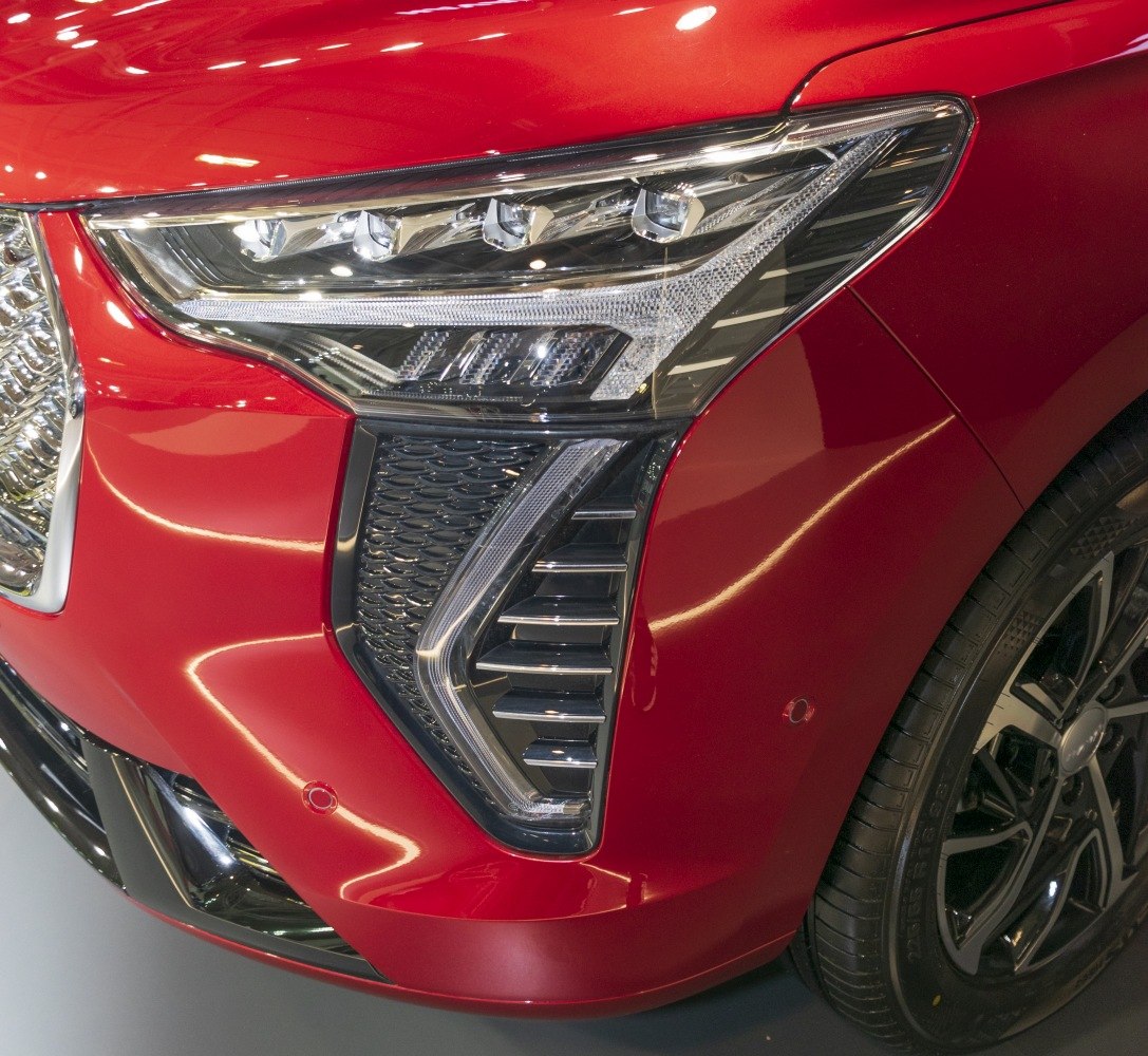 Close-up of modern front headlight and grille with wheel details