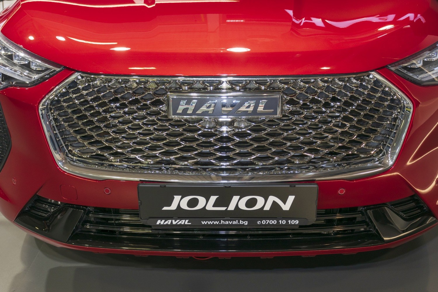 Front grille with chrome mesh and sleek headlights in red car