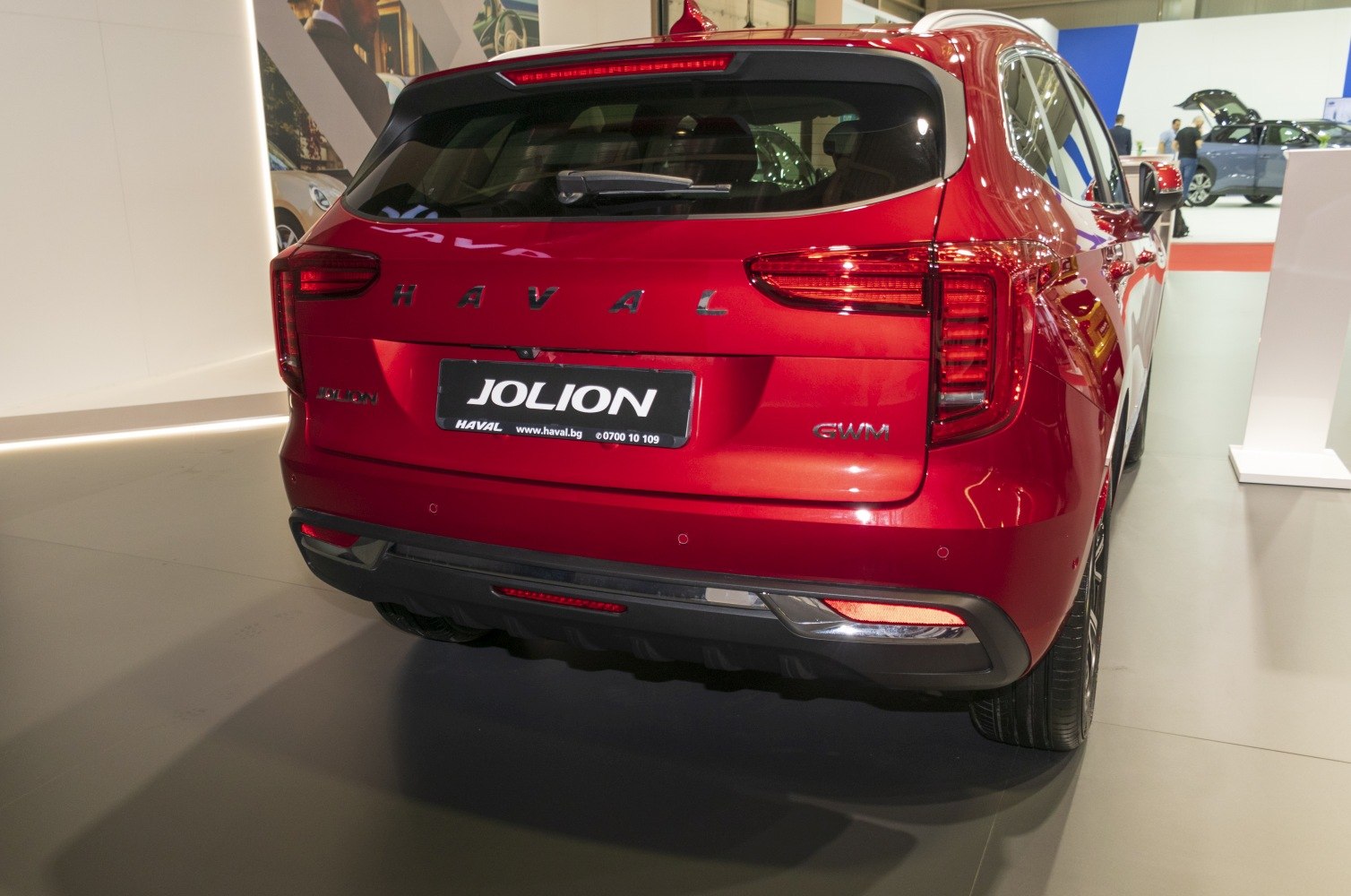 Red SUV rear view with distinctive tail lights and rear design features