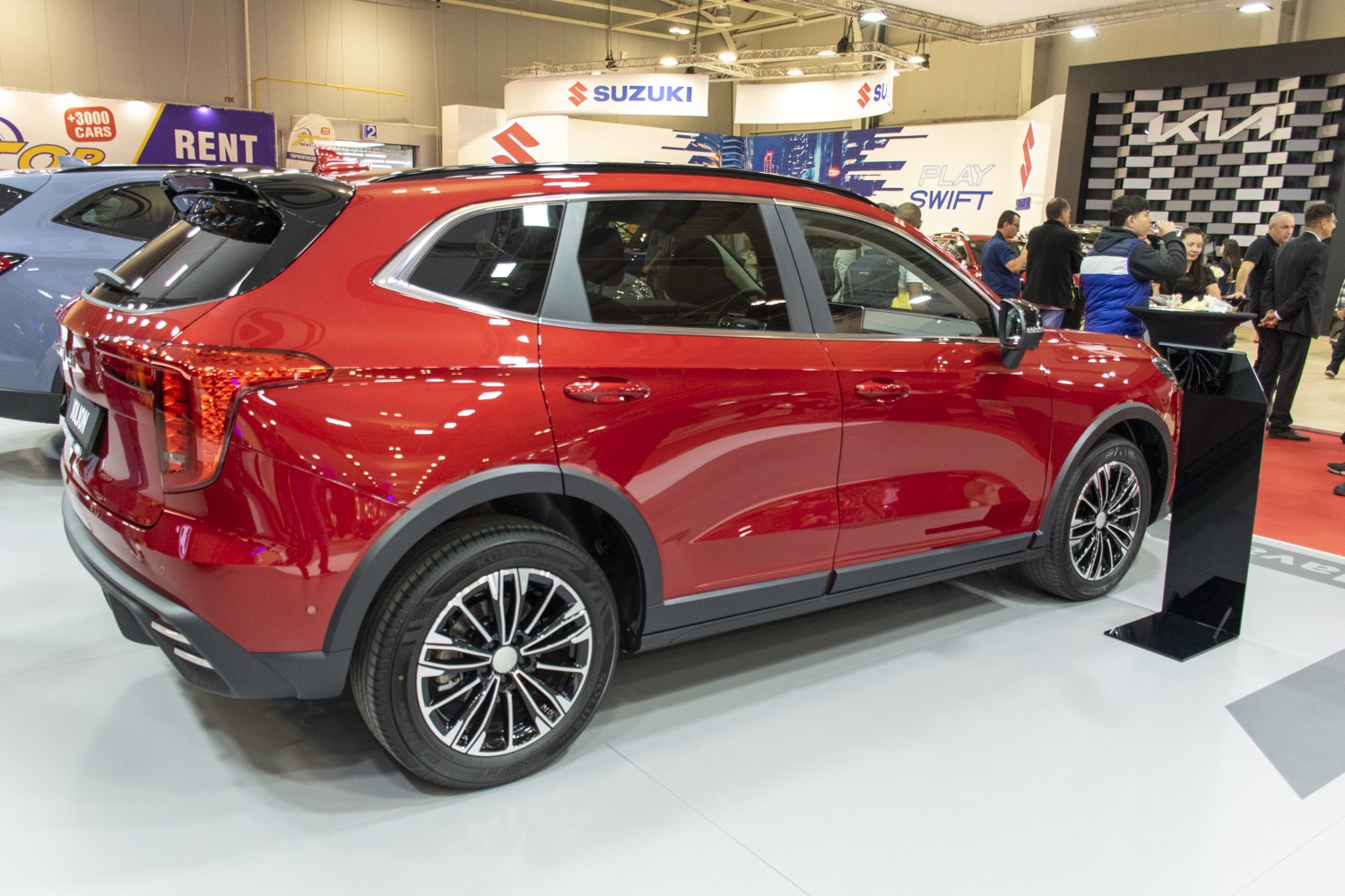 Red crossover SUV side view with alloy wheels and roof rails