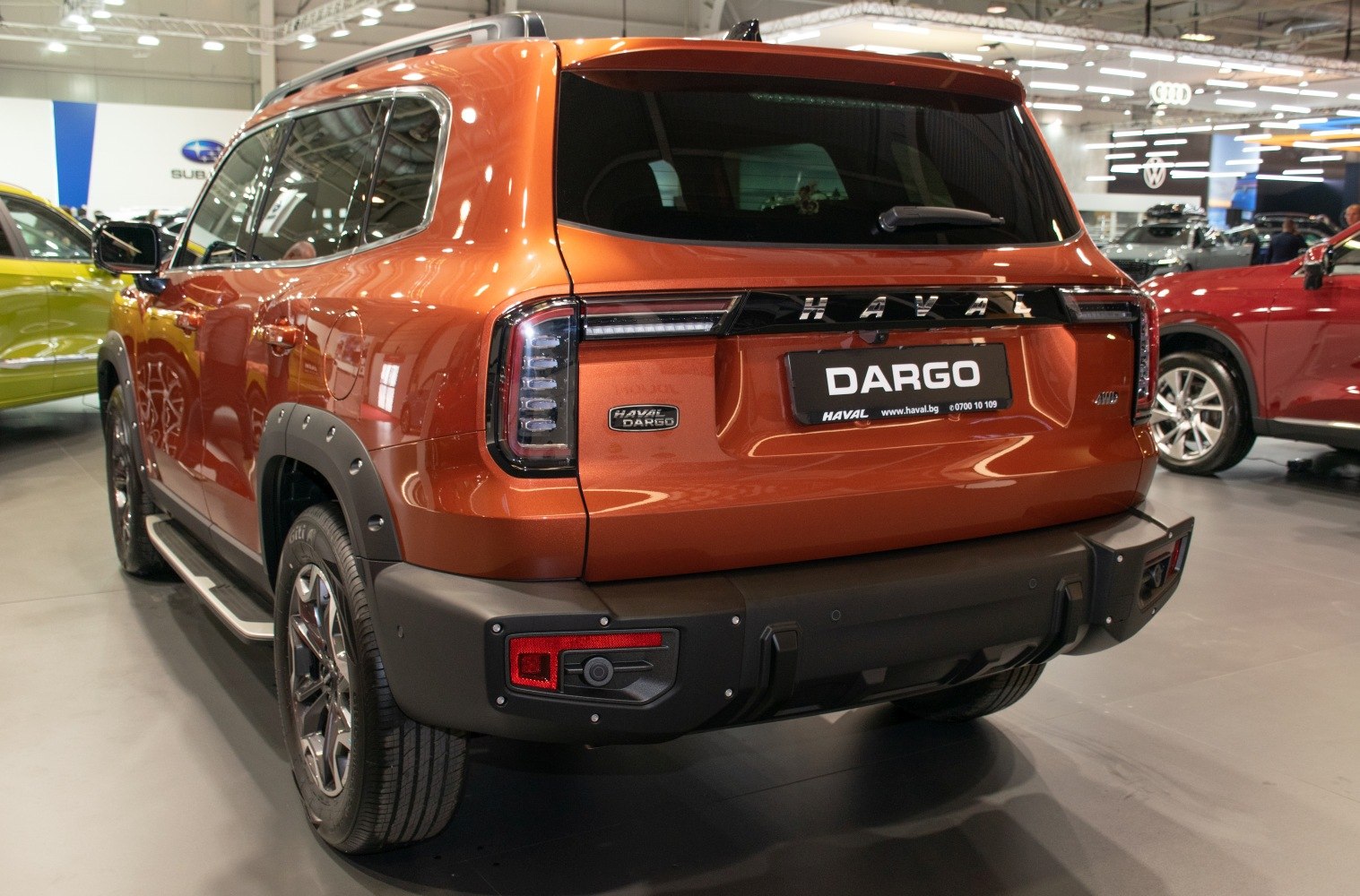 Distinctive taillights and robust rear bumper on an orange SUV
