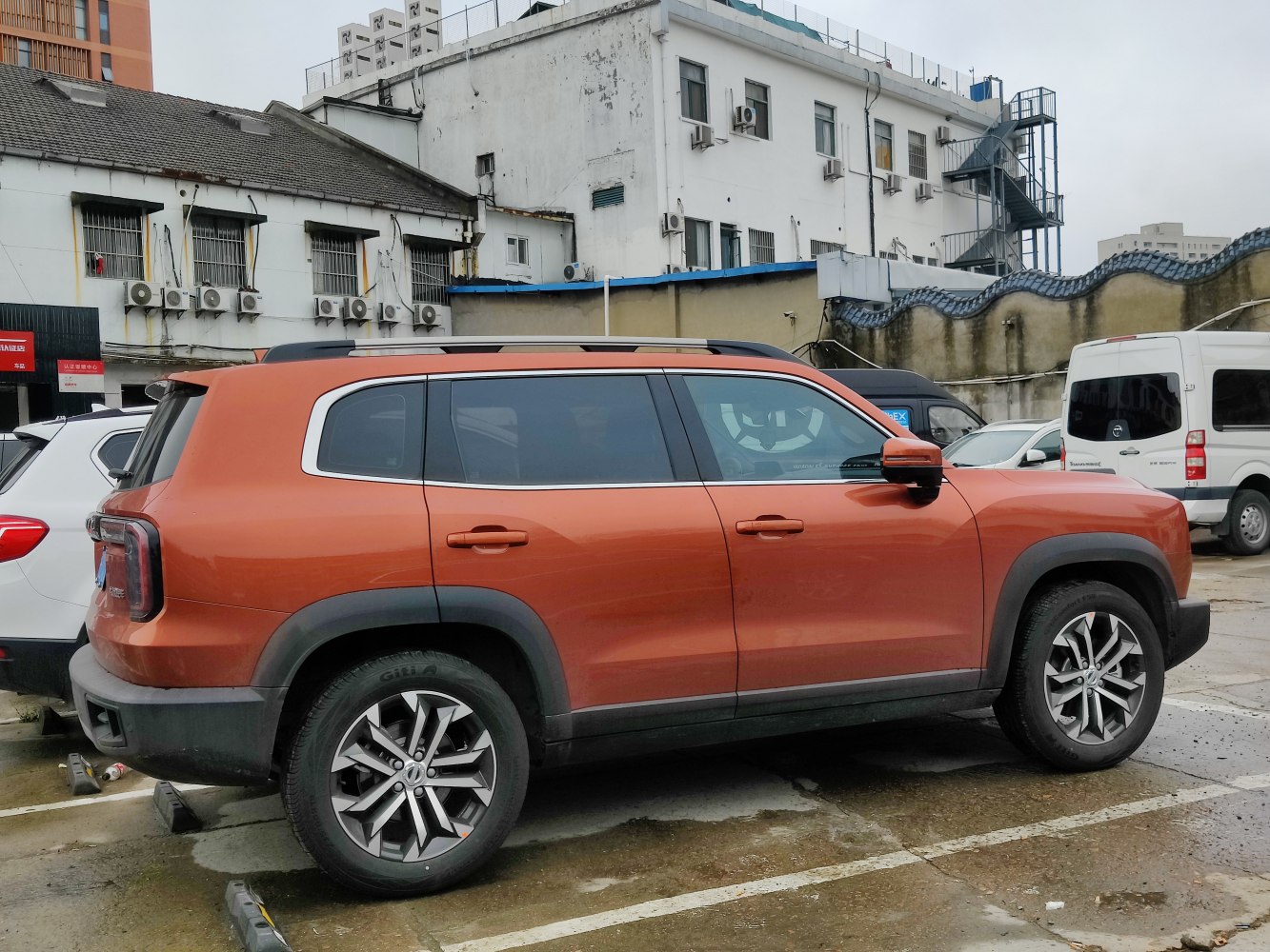 Orange SUV with black wheel arches and sporty alloy wheels