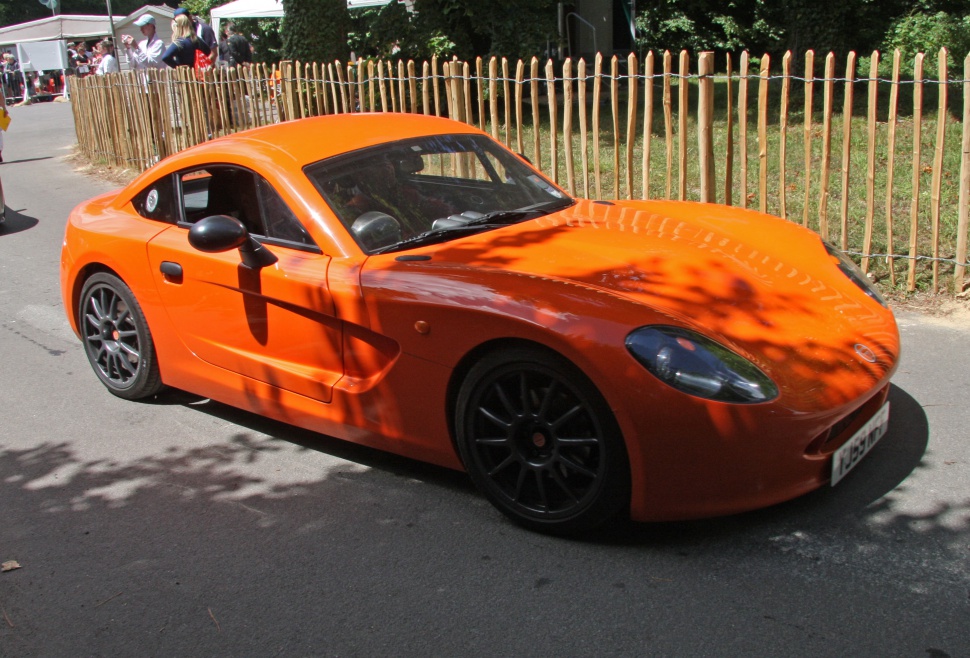 Orange sports coupe with black wheels