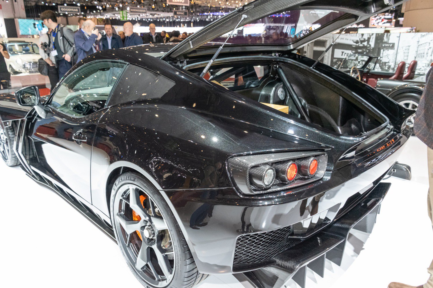 Sporty rear view with open trunk and carbon fiber details