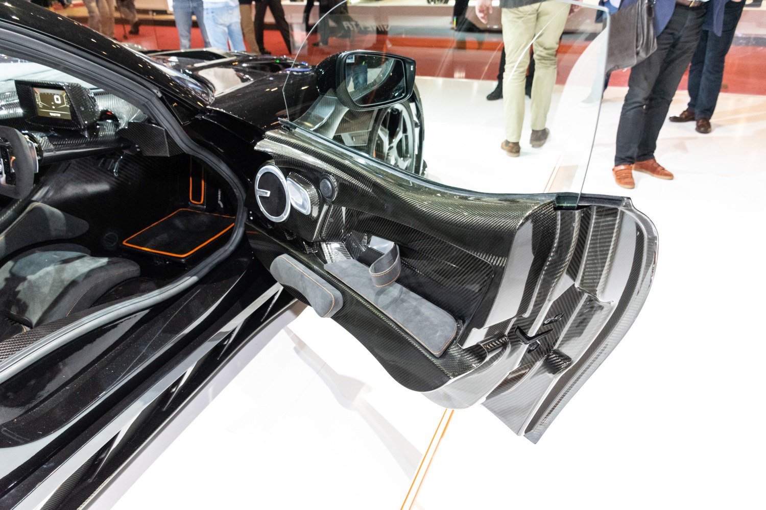 Carbon fiber sports car door interior with Alcantara pads and sleek design