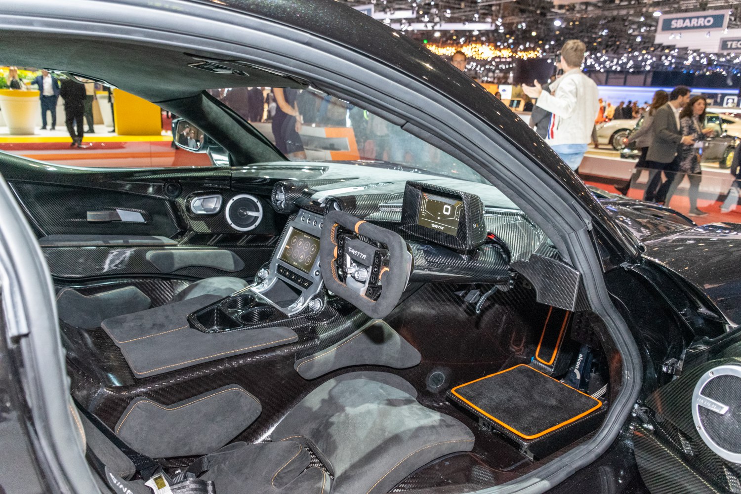 Carbon fiber racing interior with digital display and specialized steering wheel