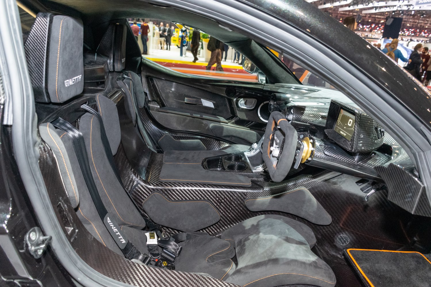 Carbon fiber interior with racing bucket seats and digital instrumentation