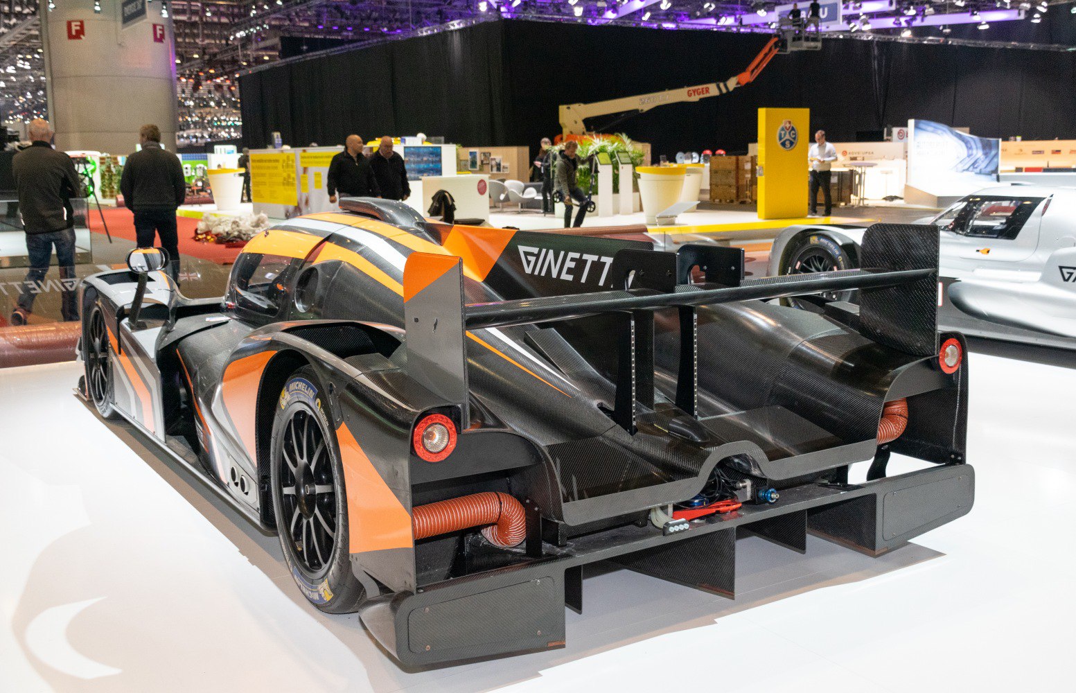 Rear view of a race car with large aerodynamic rear wing and racing slick tires
