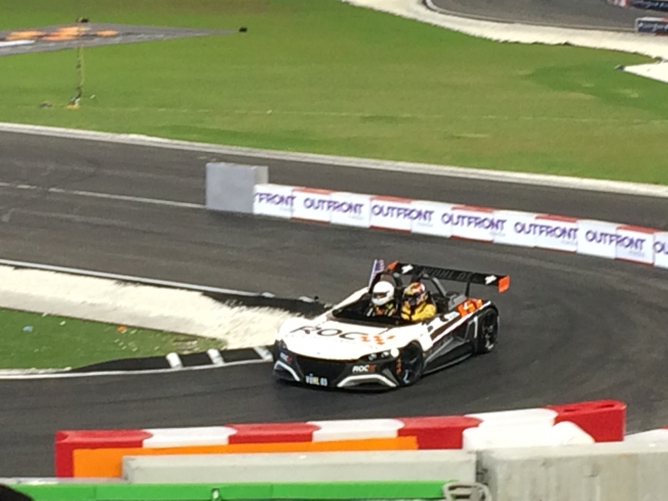 Racecar on track with aerodynamic rear wing and open cockpit