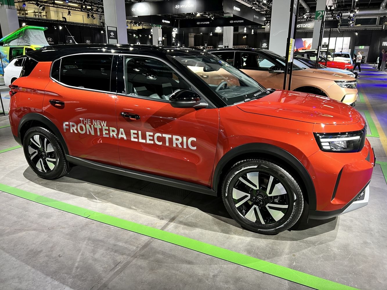 Side profile of an electric SUV with modern LED headlights and black roof