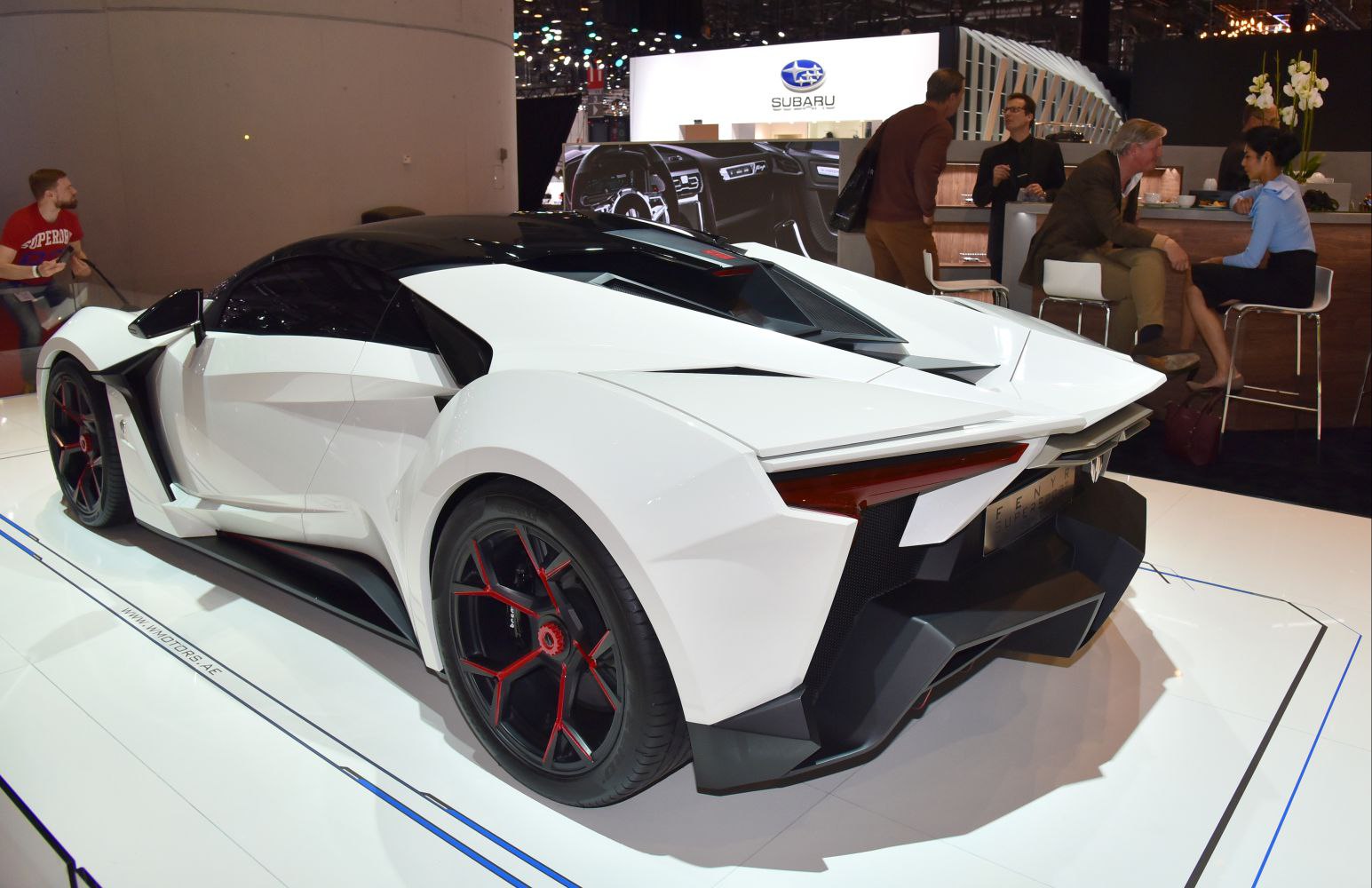 White futuristic aerodynamic rear with red-accented wheels and angular body panels.
