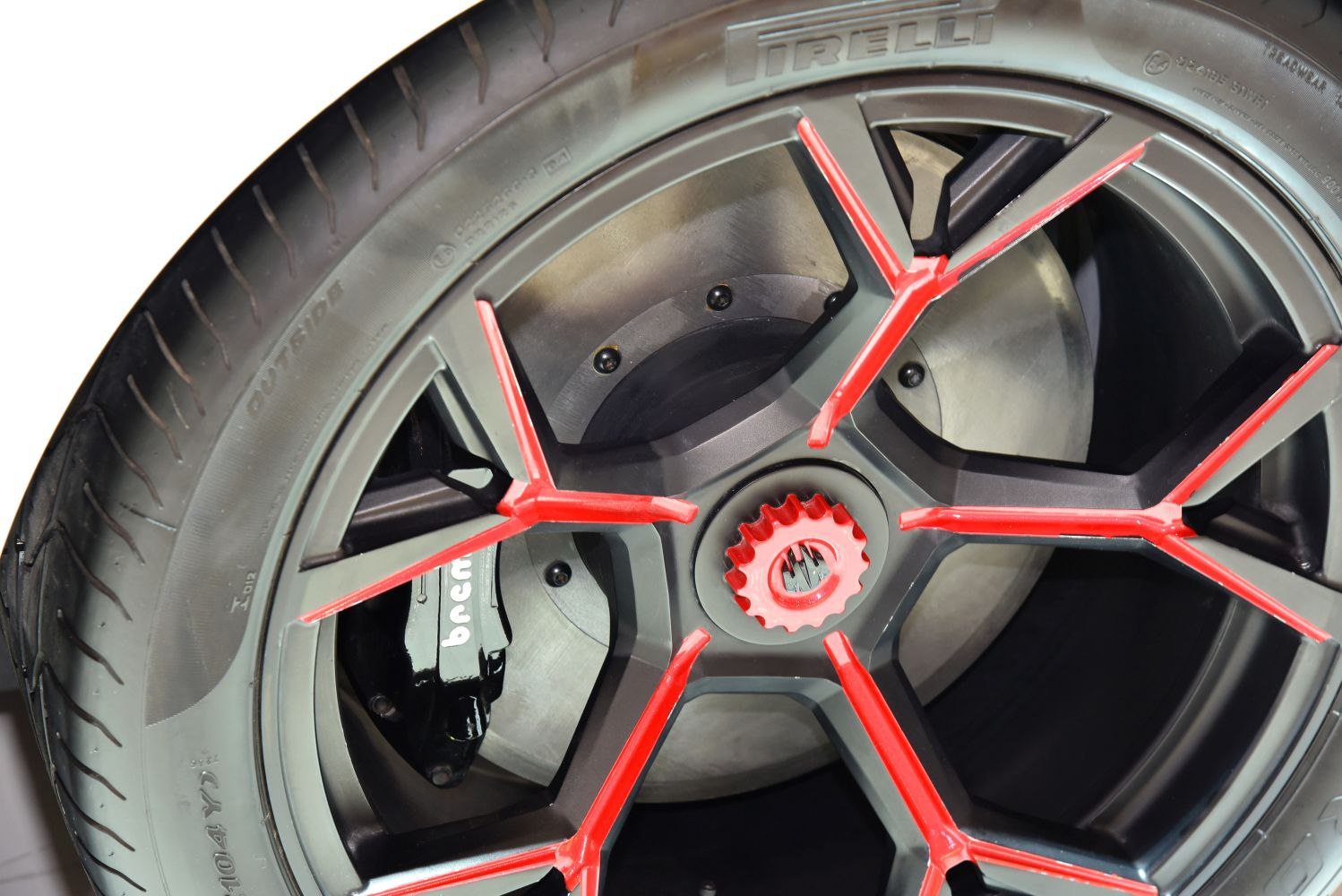Red-accented alloy wheel with visible Brembo brake caliper