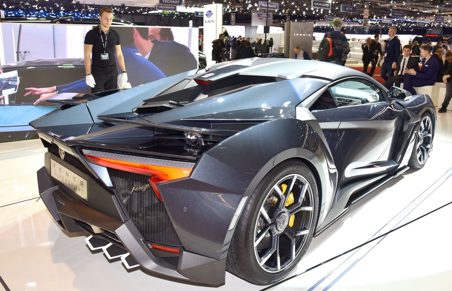 Rear and side view of a sleek high-performance sports car with aerodynamic features and carbon fiber elements