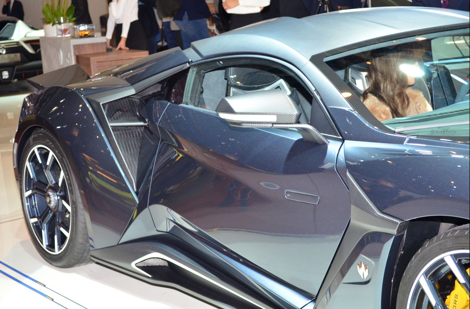 Side profile with carbon fiber mirror and detailed wheel design