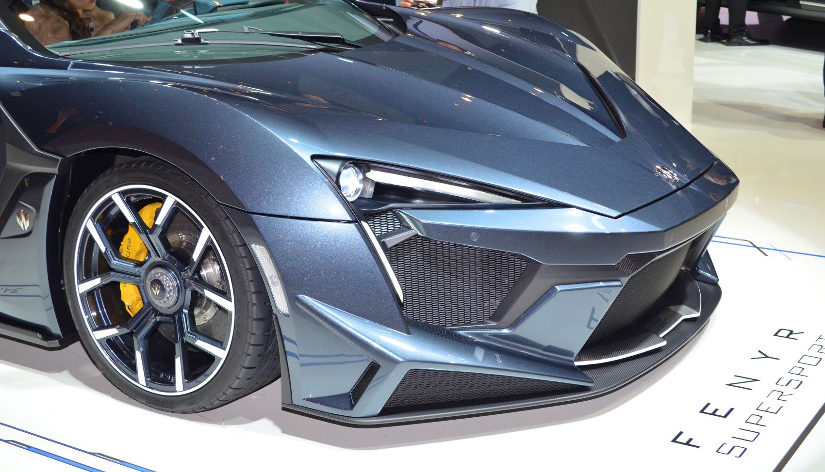 Aggressive front bumper with alloy wheel and yellow caliper