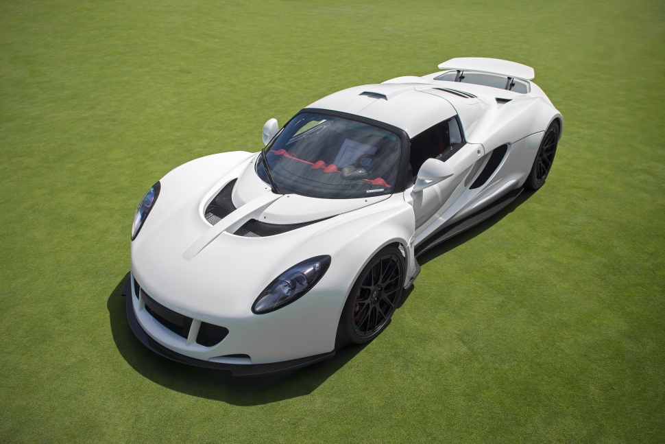 White sports coupe with aerodynamic features and rear wing