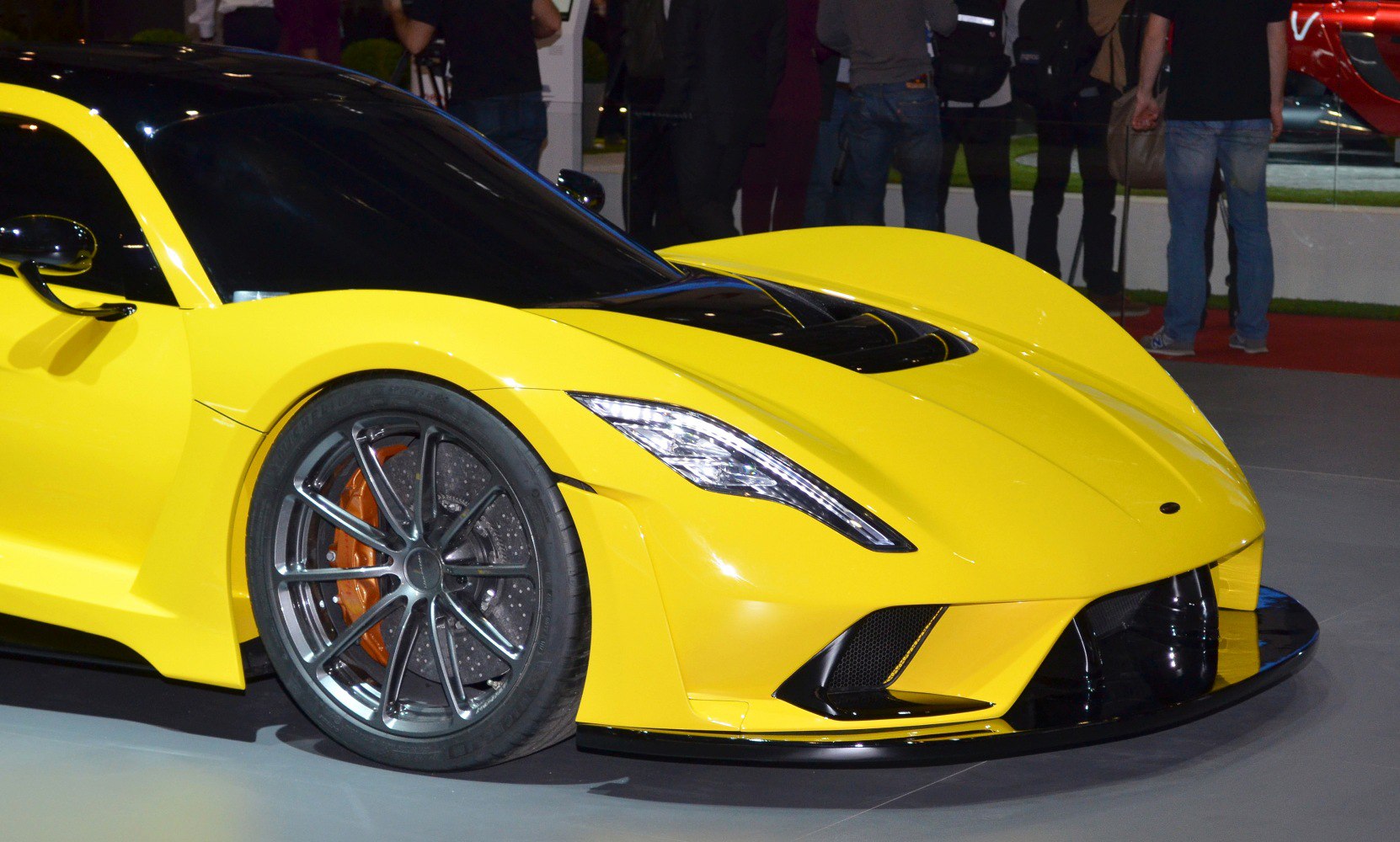 Aerodynamic yellow supercar front with alloy wheels and carbon ceramic brakes
