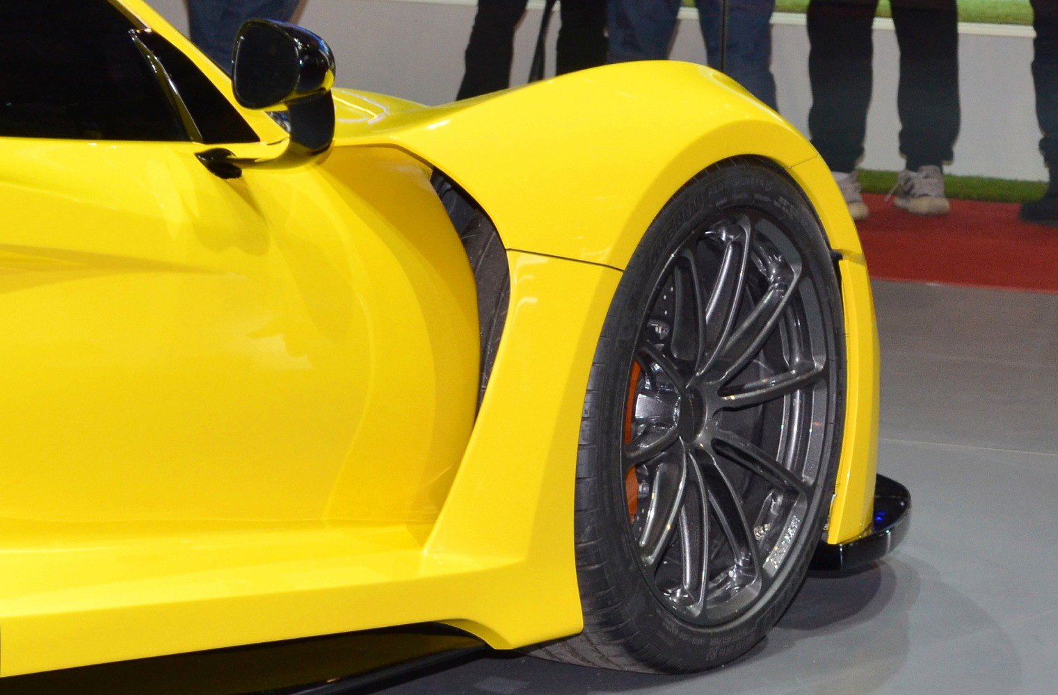 Yellow car front wheel with aerodynamic fender vent