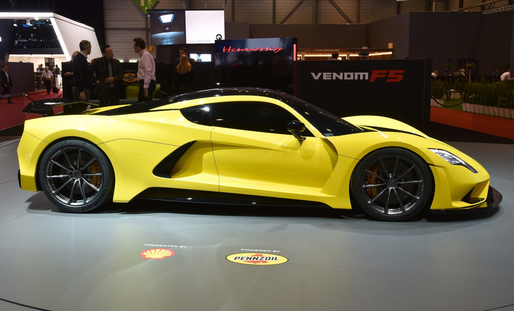 Aerodynamic yellow sports coupe with large wheels and tinted windows