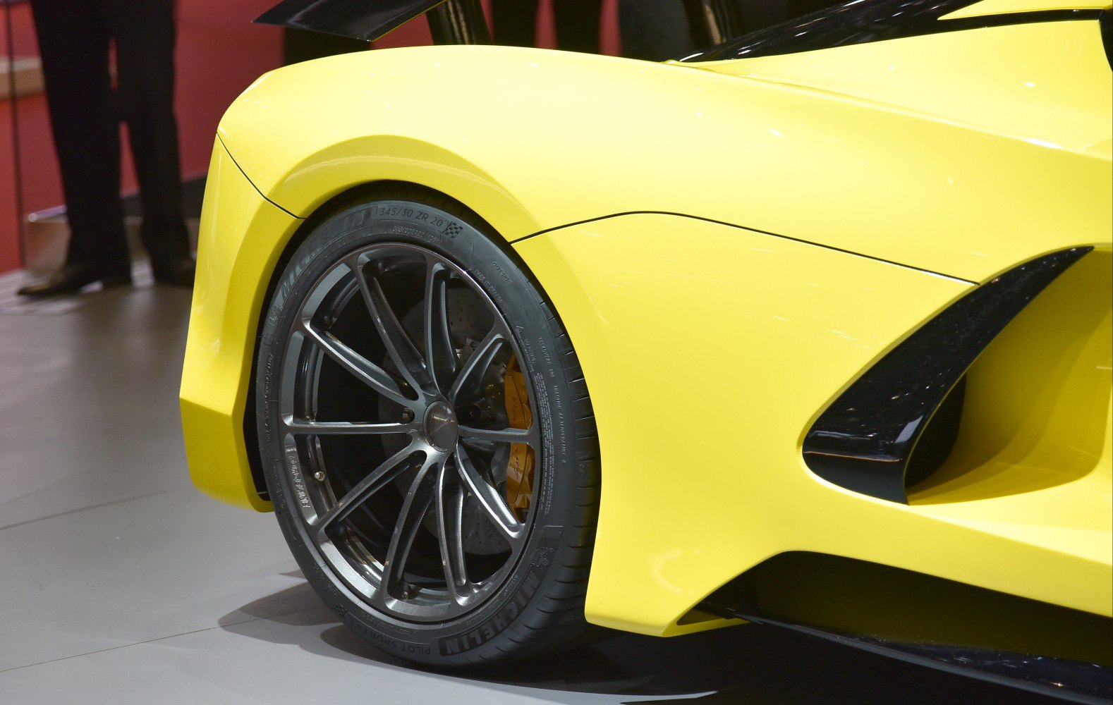 Rear wheel with alloy rim and aerodynamic side vent on yellow body