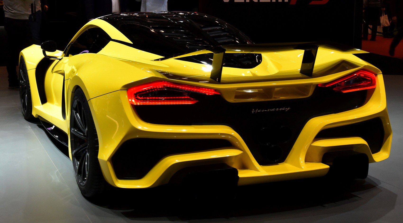 Sleek supercar rear with aerodynamic spoiler and illuminated taillights