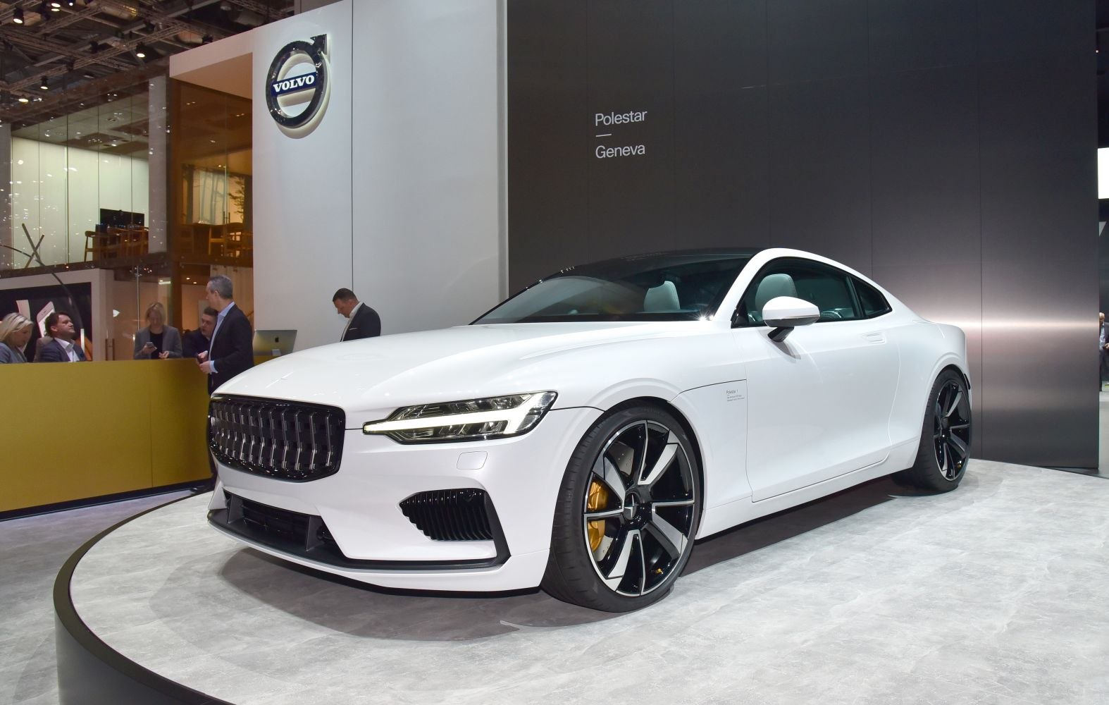 White coupe with black roof and large multi-spoke wheels