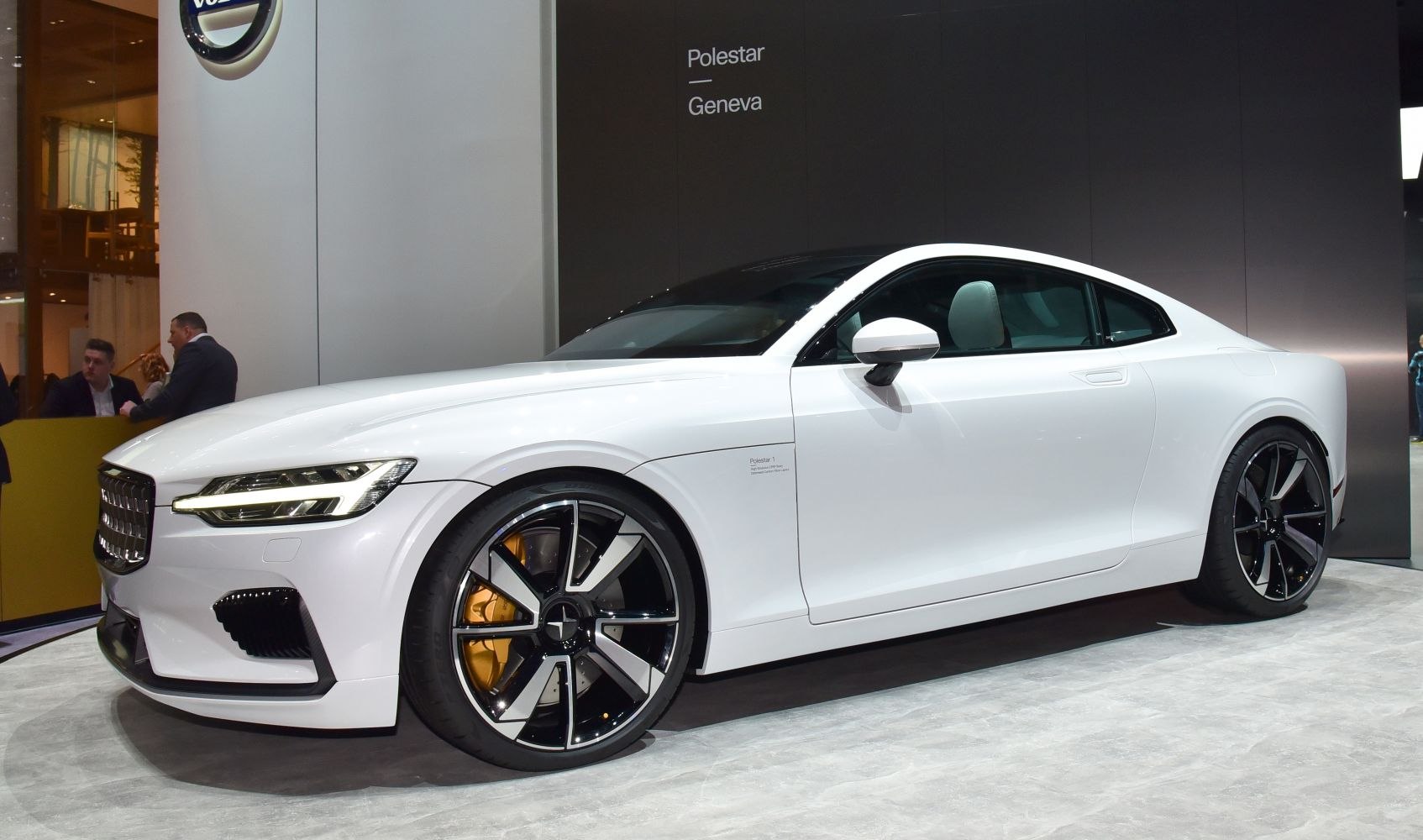Front side view of luxury white coupe with LED headlights and stylish wheels