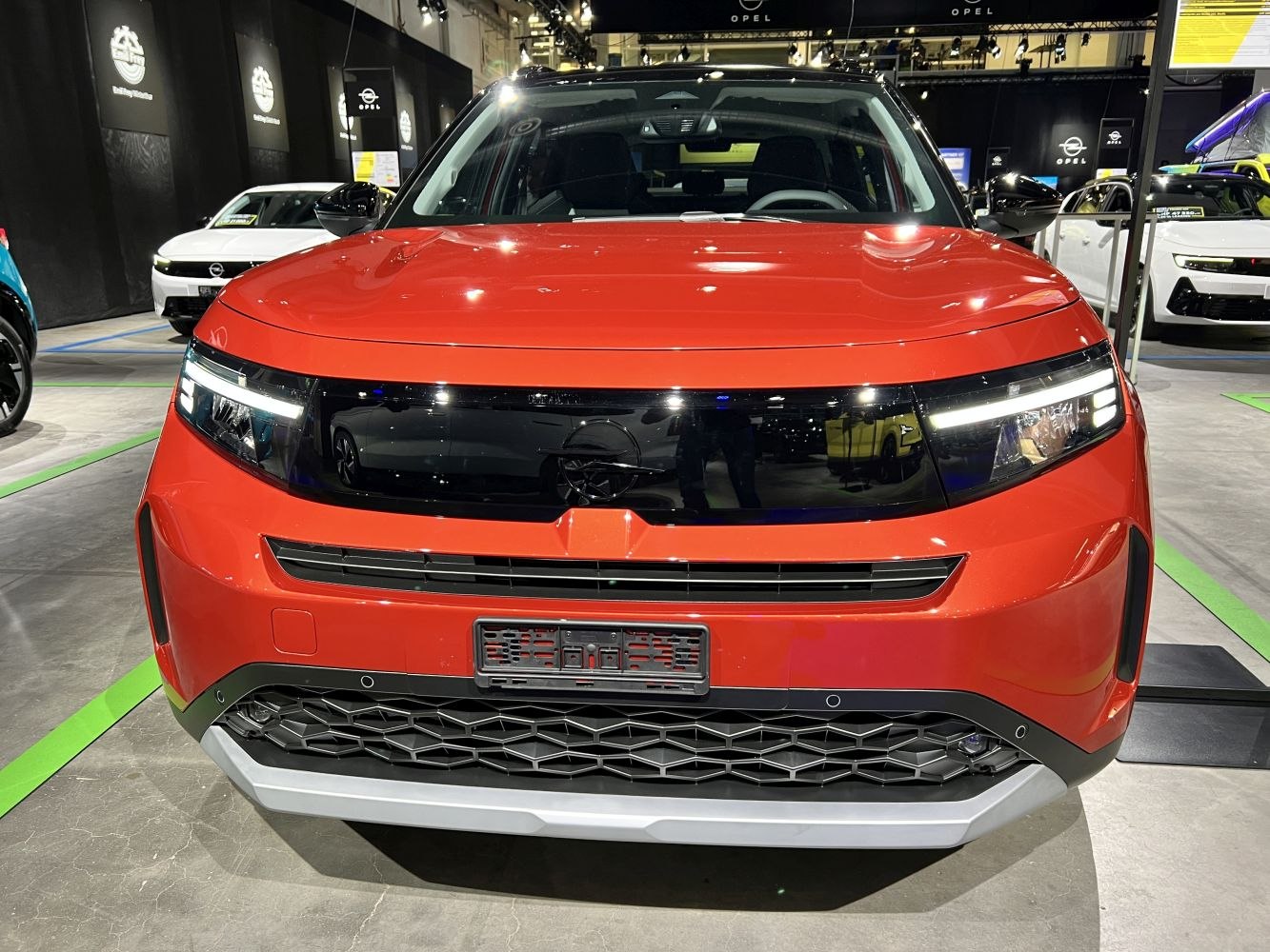 Front view of a modern SUV with LED headlights and bold grille