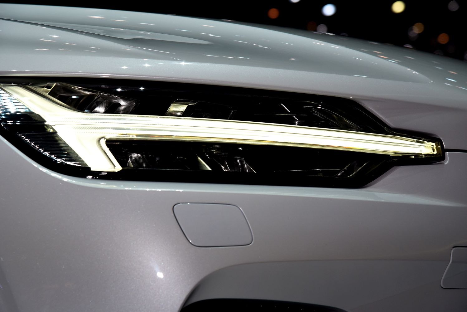 Close-up of modern LED front headlight with sleek design.