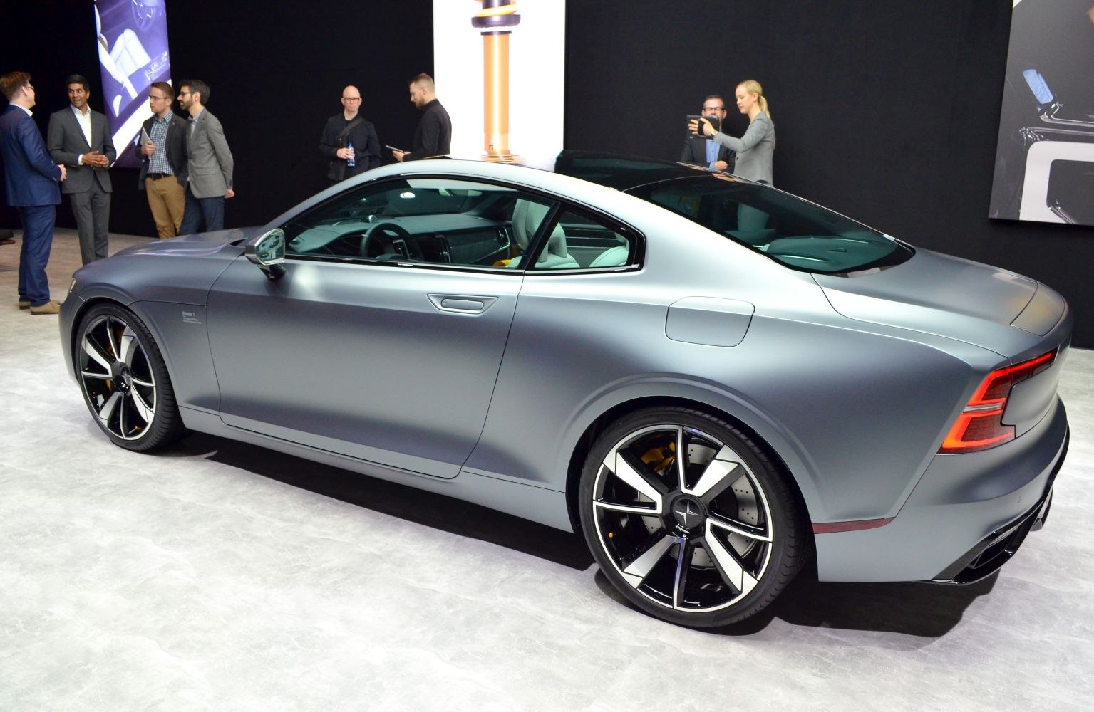 Matte grey sporty two-door coupe with large black and silver alloy wheels.