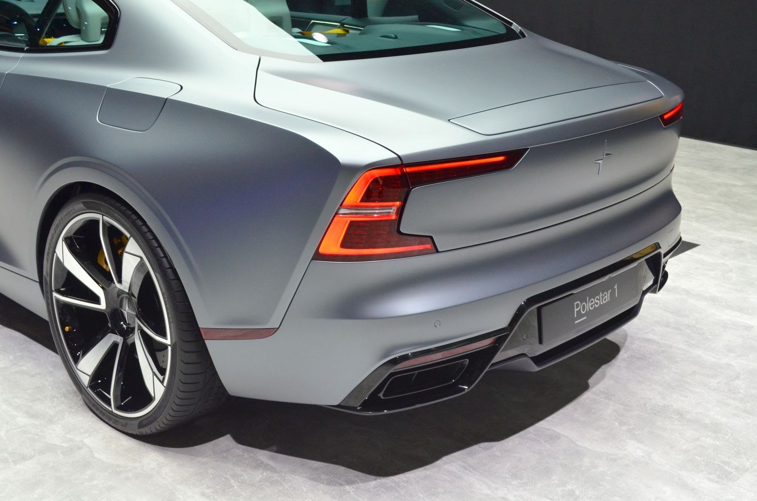 Rear design showcasing tail lights, alloy wheel, and bumper details