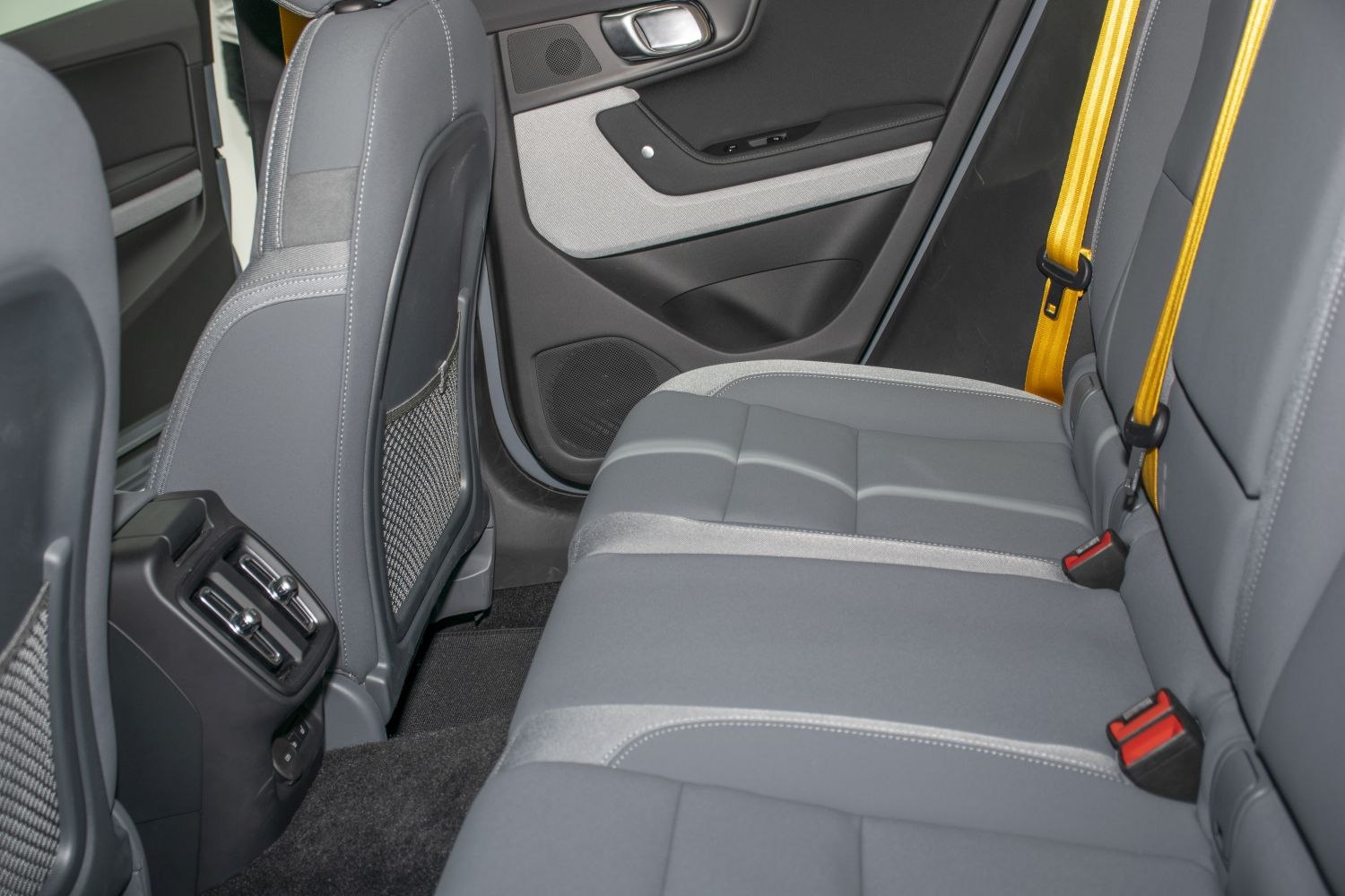 Gray rear seats with distinctive yellow seat belts and rear air vents