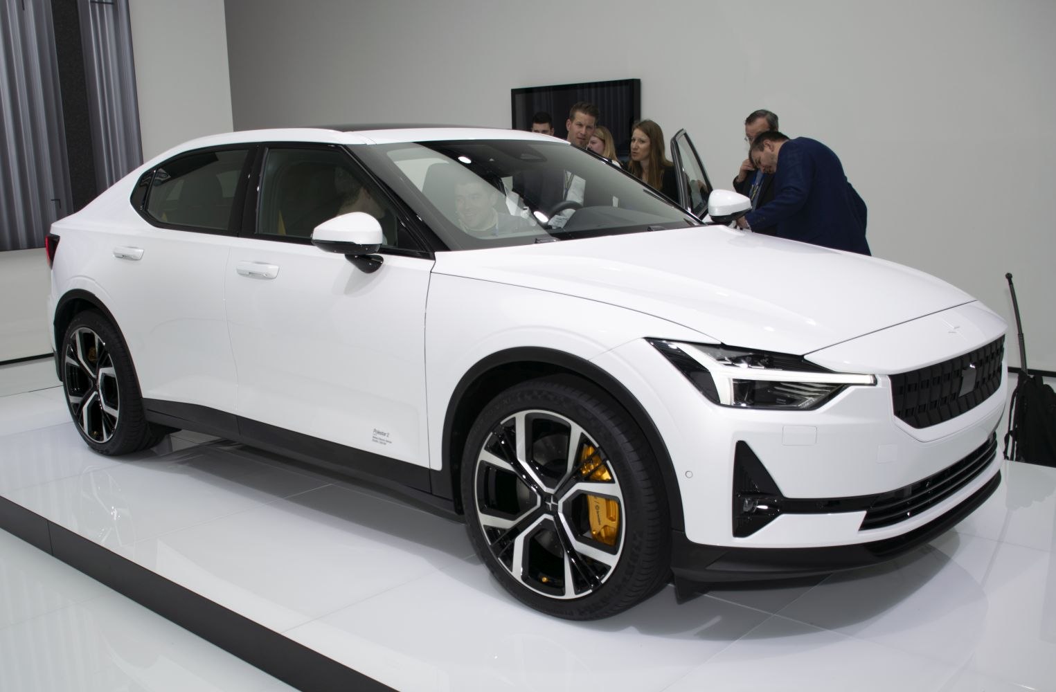 White electric sedan with LED headlights and distinctive alloy wheels