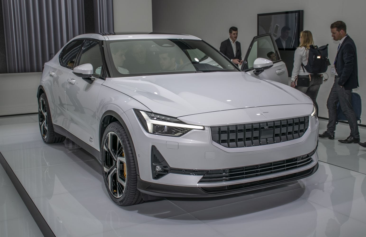 Front angled view of sleek electric compact SUV with LED headlights and distinctive grille