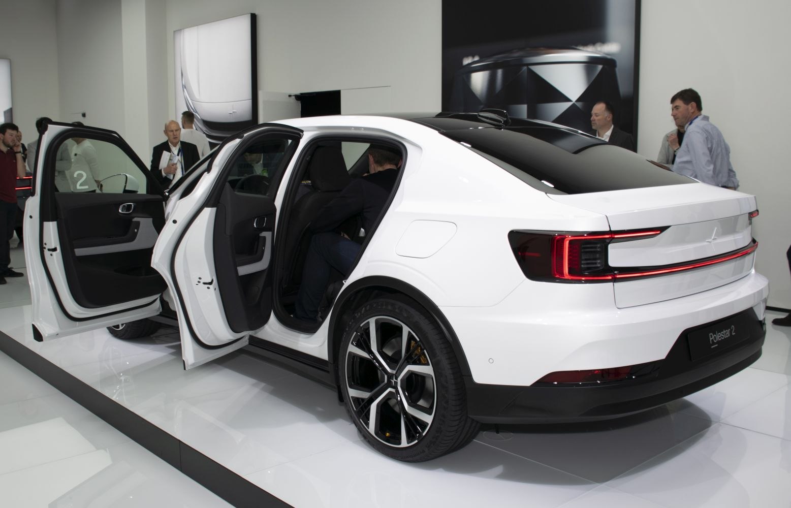 Rear side view with LED taillights, modern wheels, and open rear doors