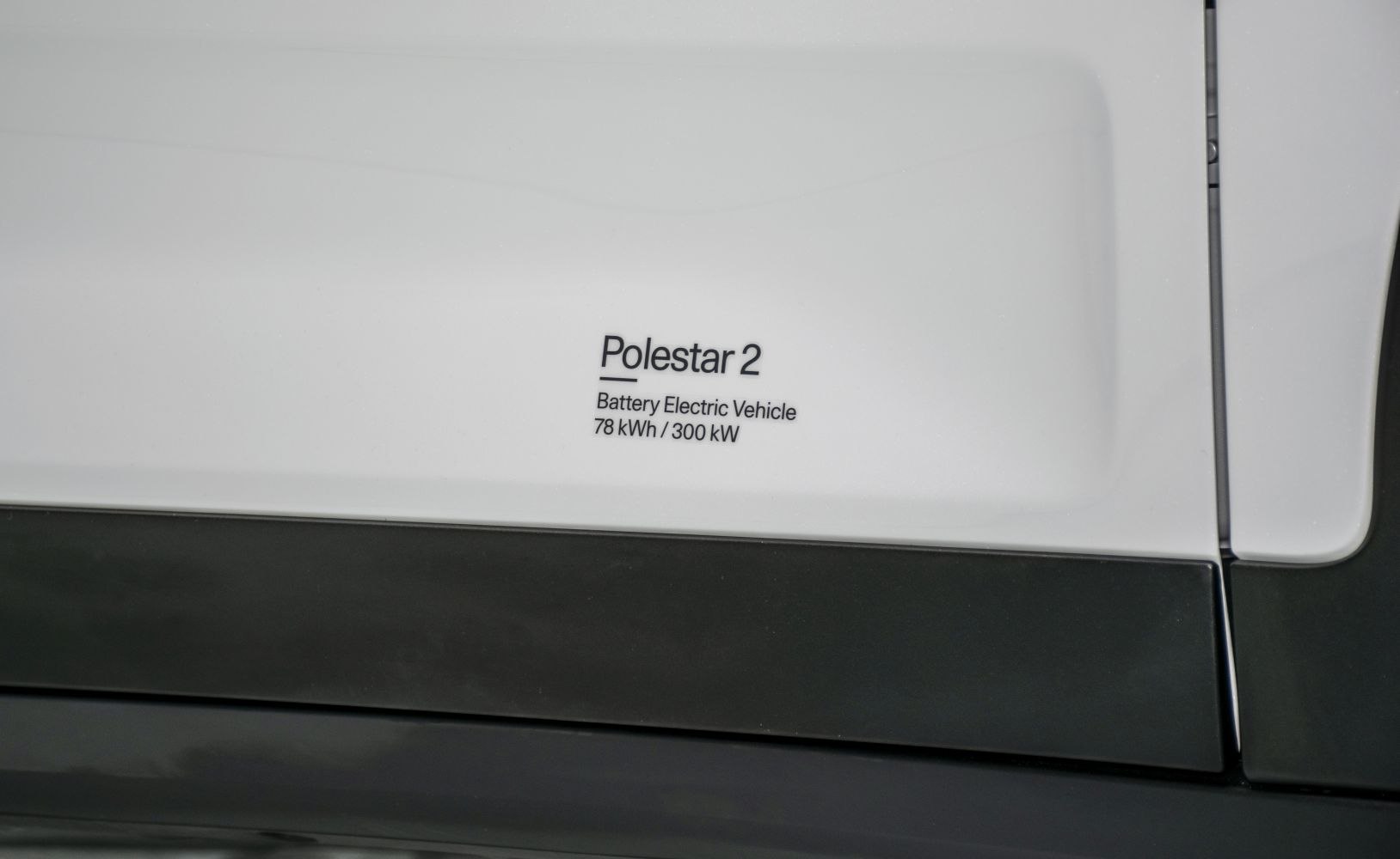 Close-up of EV badge showing battery and power specs