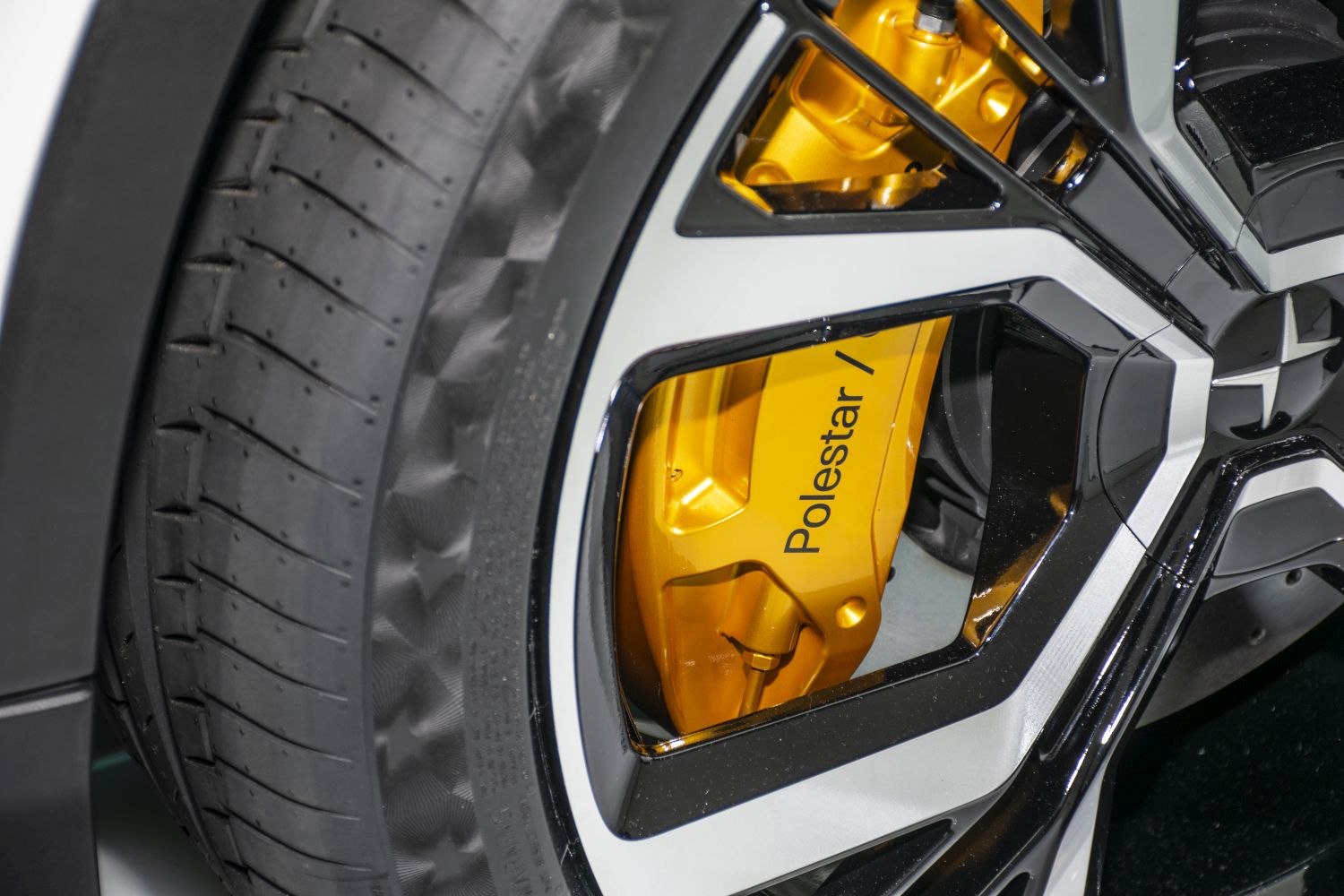 Yellow brake caliper and black-silver alloy wheel close-up