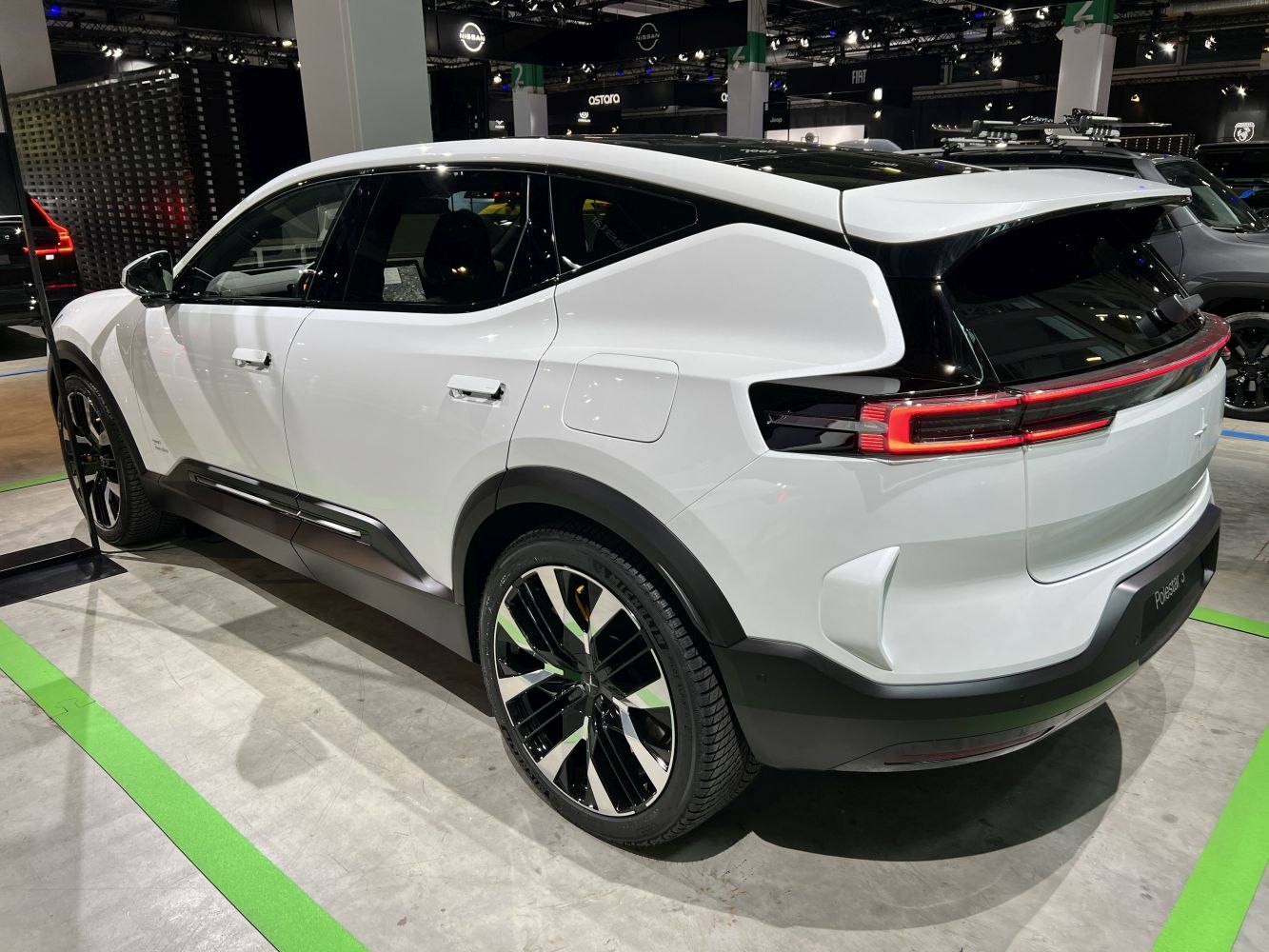 Rear side view of a white electric SUV with aerodynamic design and modern wheels
