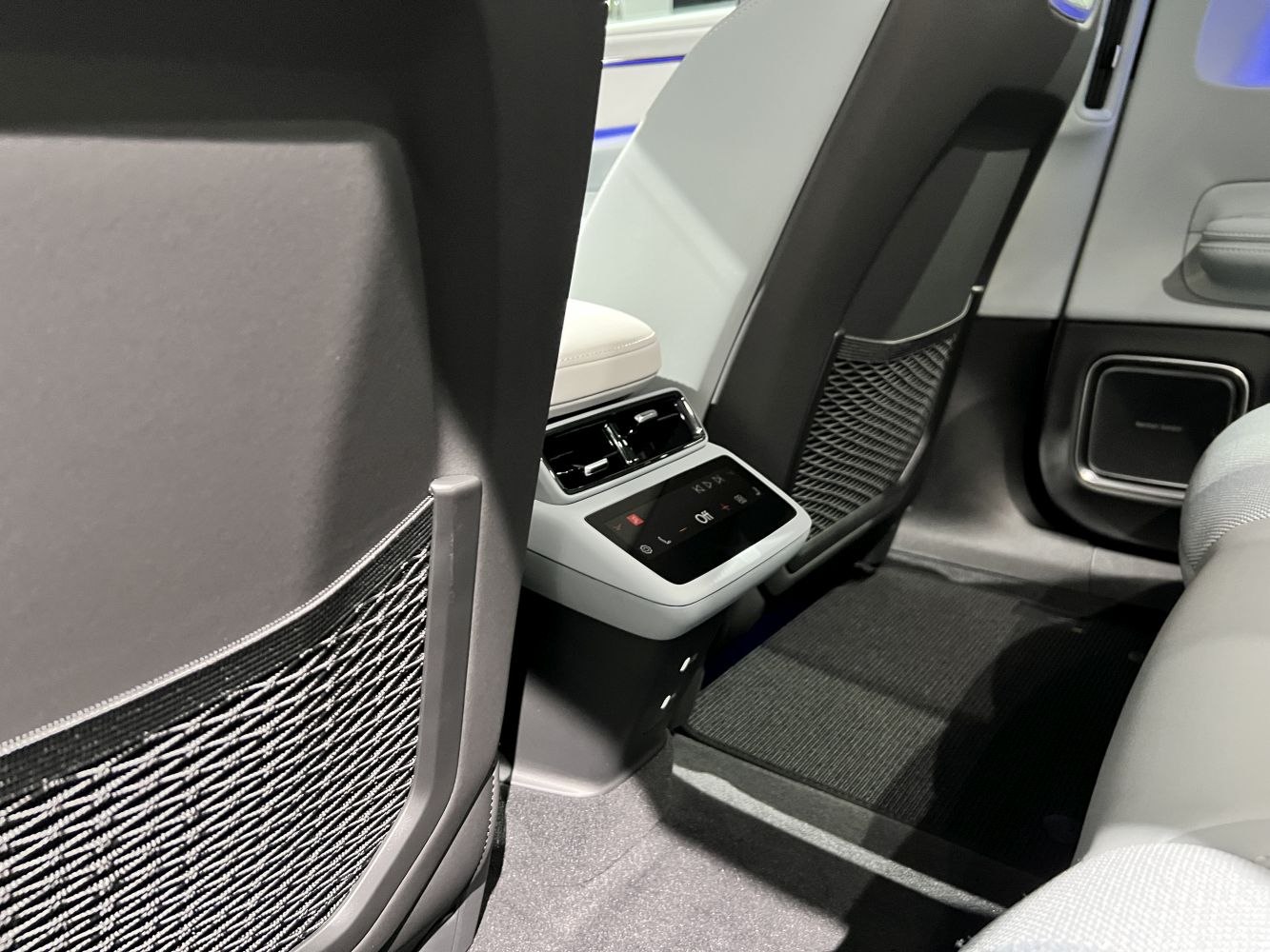 Rear climate control panel with digital display and mesh seat pockets
