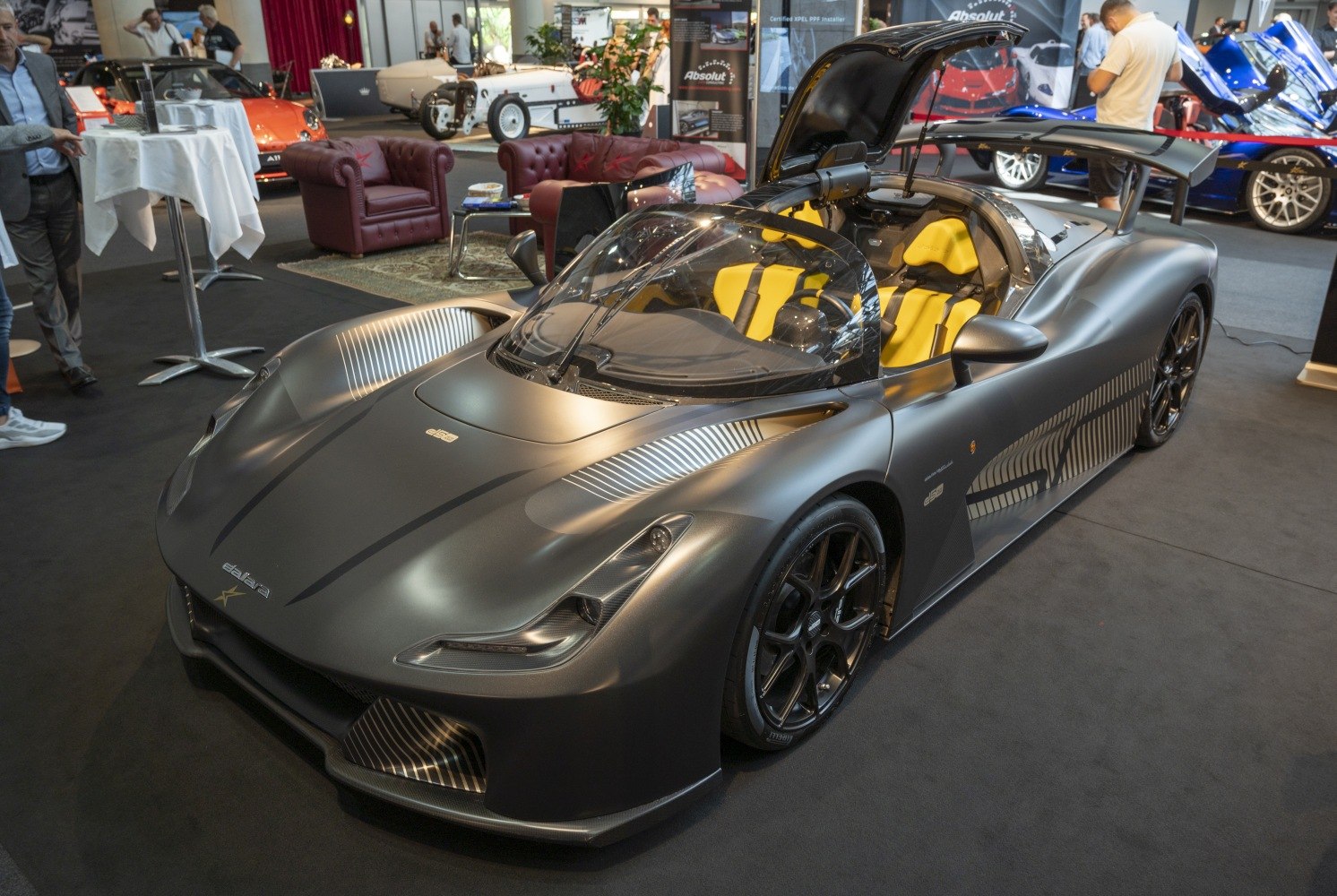 Matte grey sports car with yellow interior and rear wing spoiler